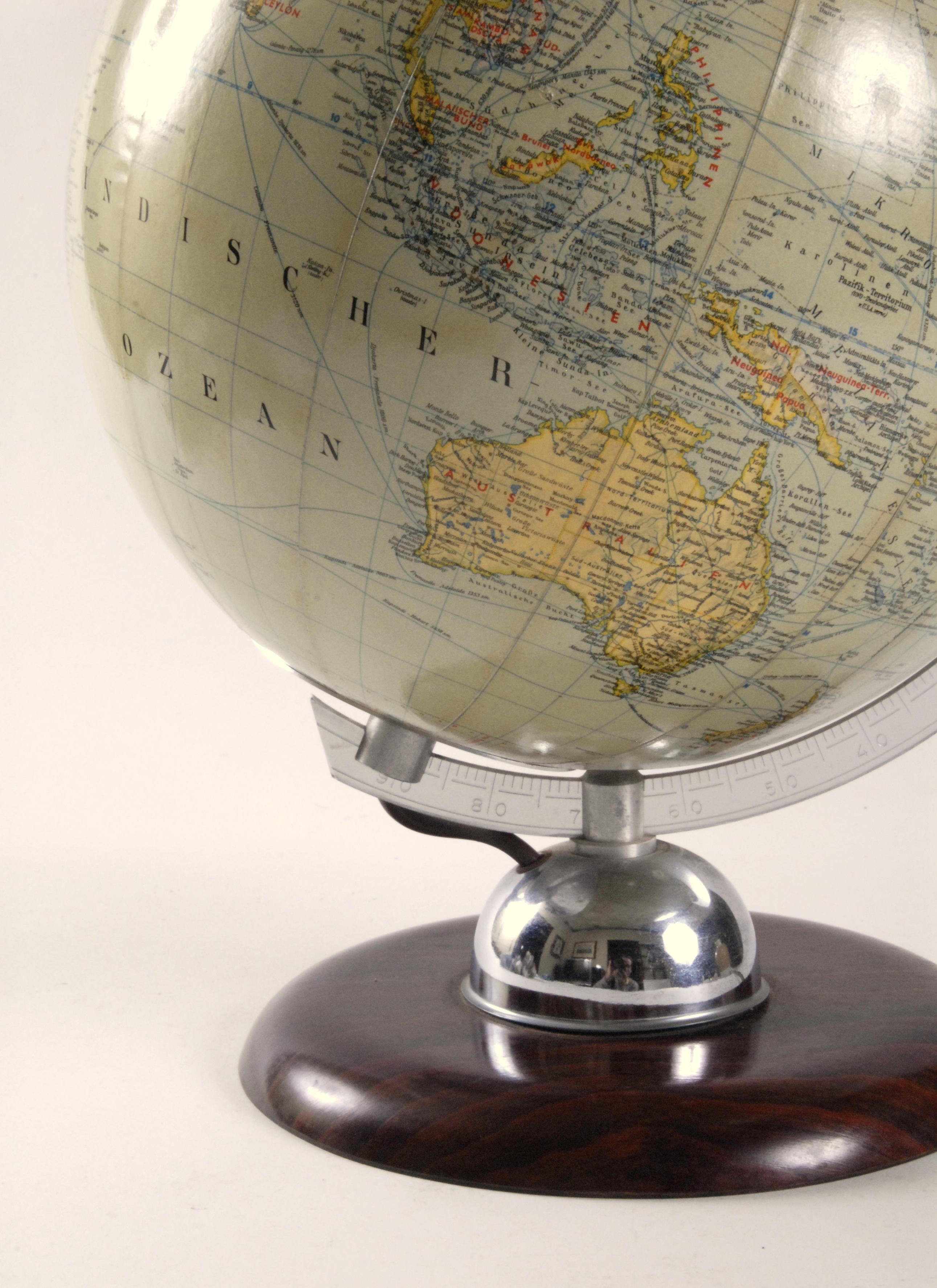 An excellent JRO made West Germany glass world globe light. Mounted on a Bakelite base with an aluminium gauge marked with latitude marks sitting on a chrome dome. The map paper is in excellent condition and when lit displays with a lovely soft warm