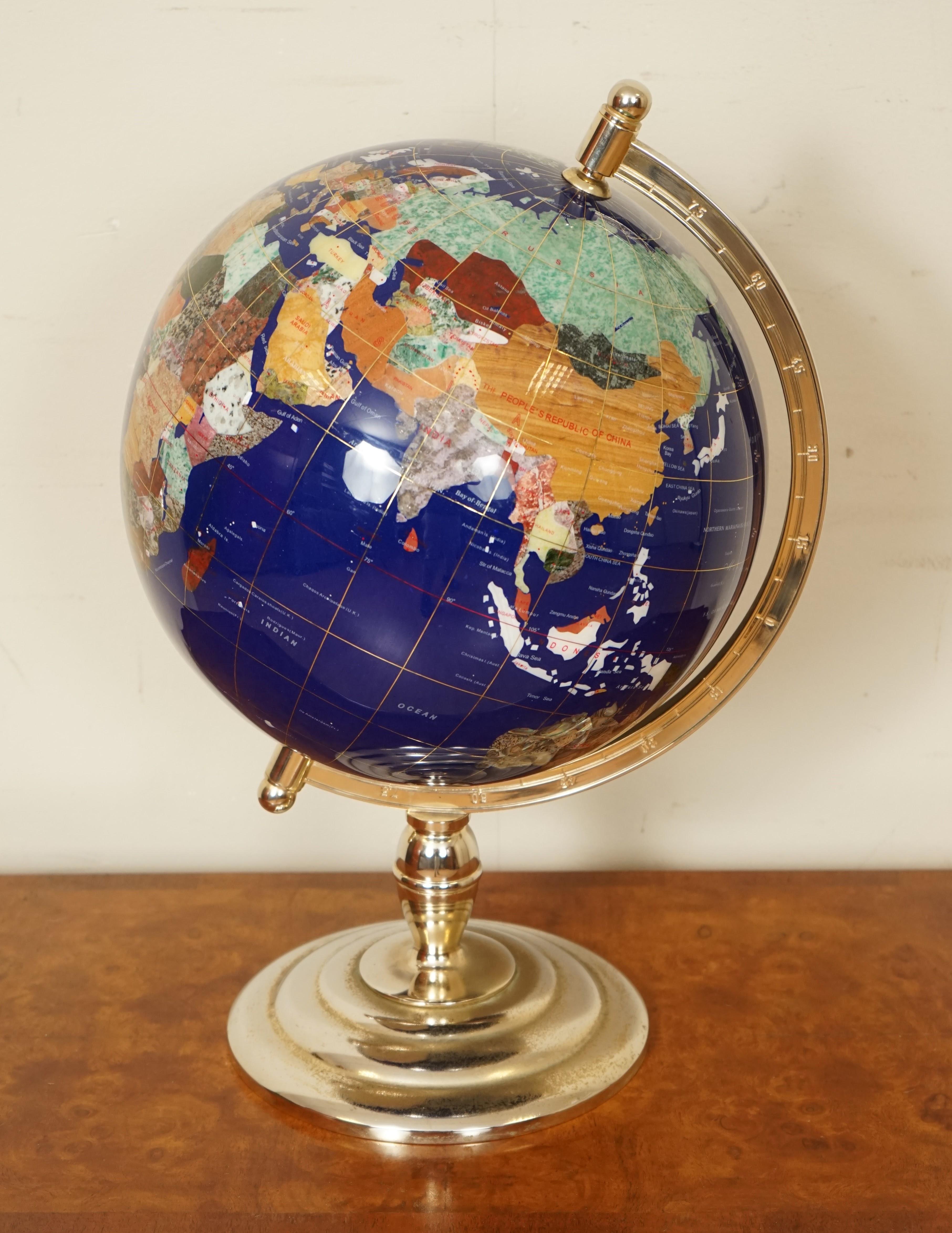 We are so excited to offer for sale this beautiful world globe.

It has a stunning solid brass stand which has been polished.

As mentioned in the title the globe is made of precious gemstones from all over the world.

 The water is made from