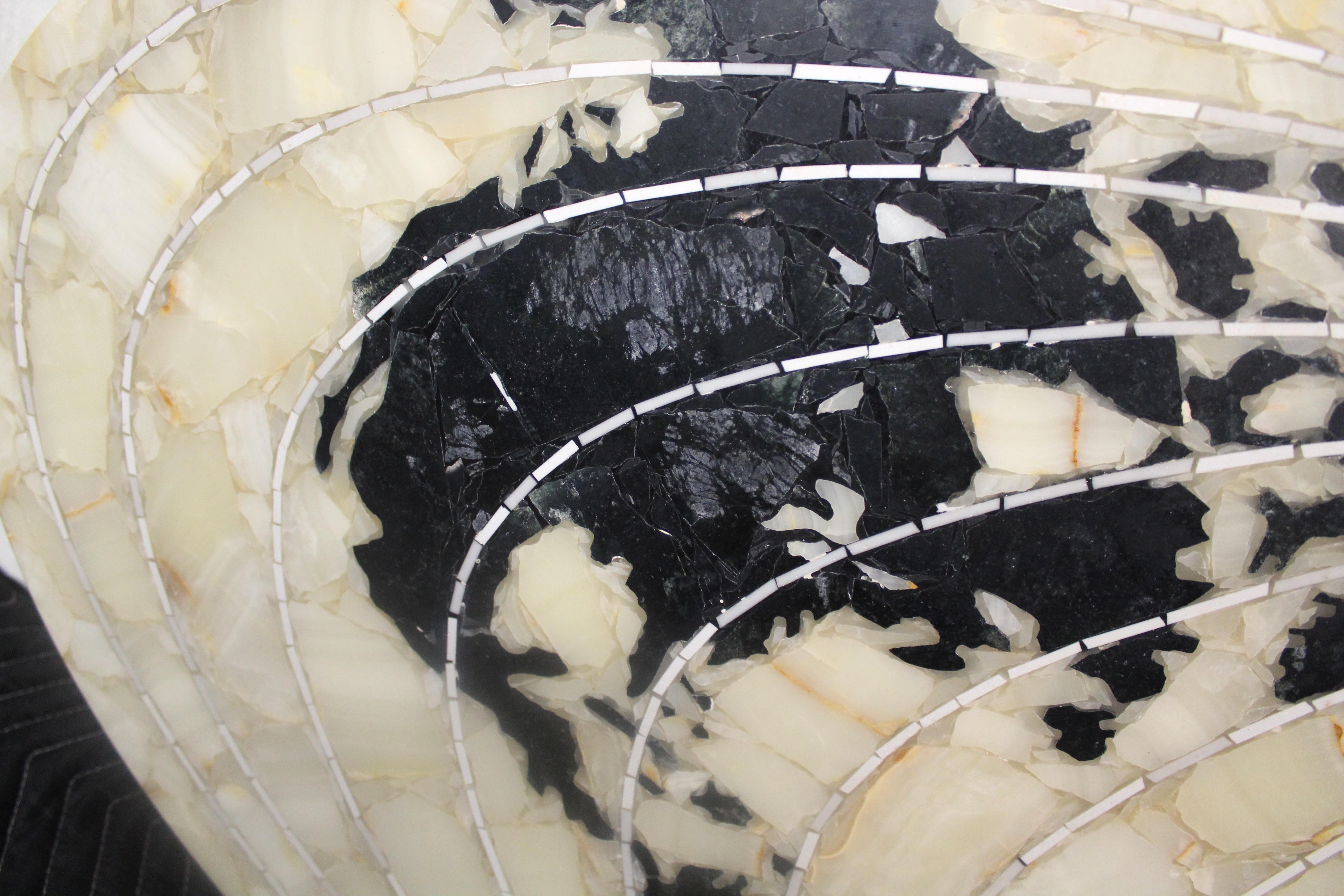 This magnificent art sculpture is made up of intricately inlaid stone to make up the world globe. The juxtaposition of marble and onyx is further accentuated by the white latitude lines made of hand cut pieces.
Please confirm location NY or NJ