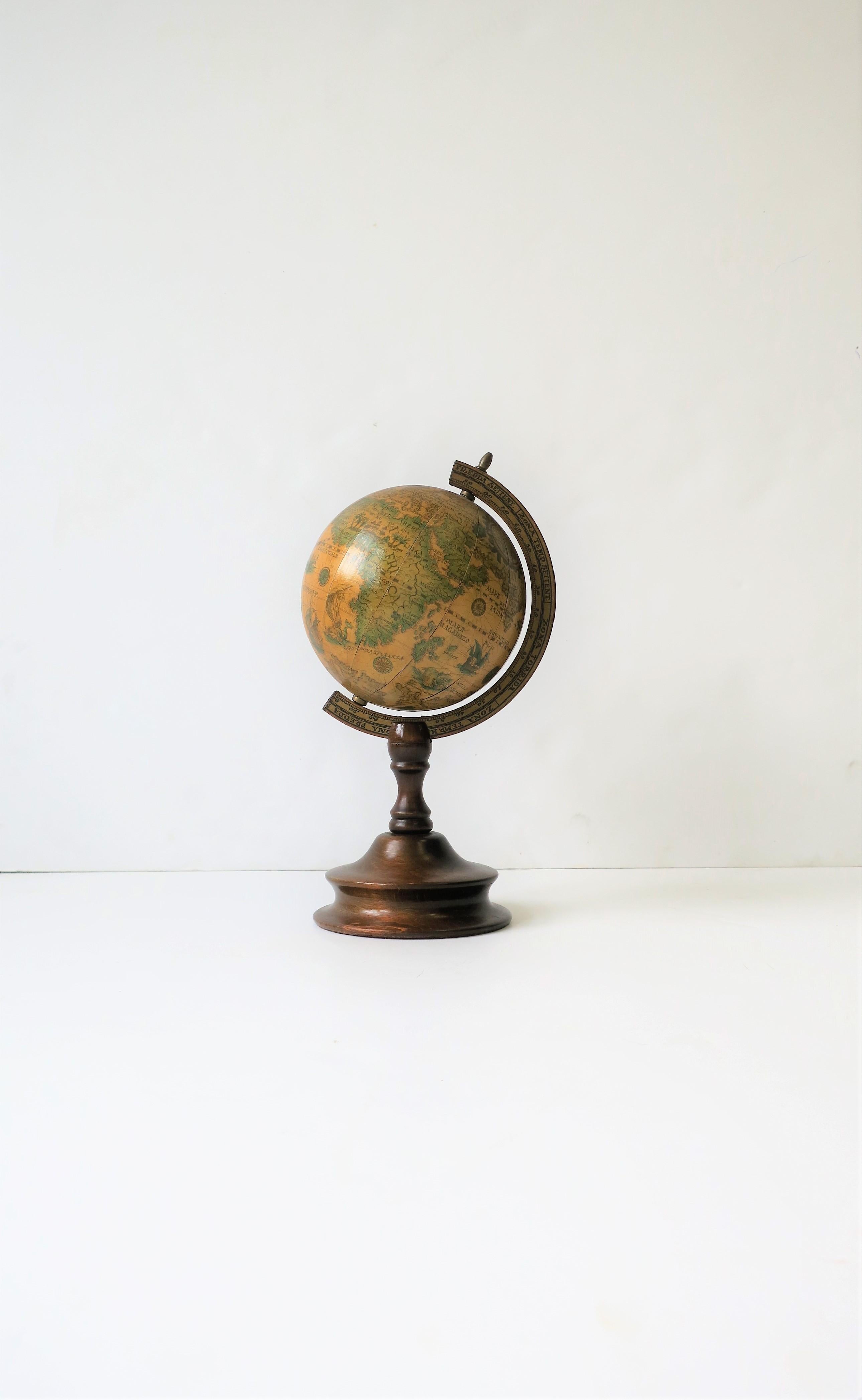 A mid-20th century world globe that spins. Piece has a wood frame with brass hardware. A great decorative object for a bookshelf, étagère, desk, office, etc. Measures: 6