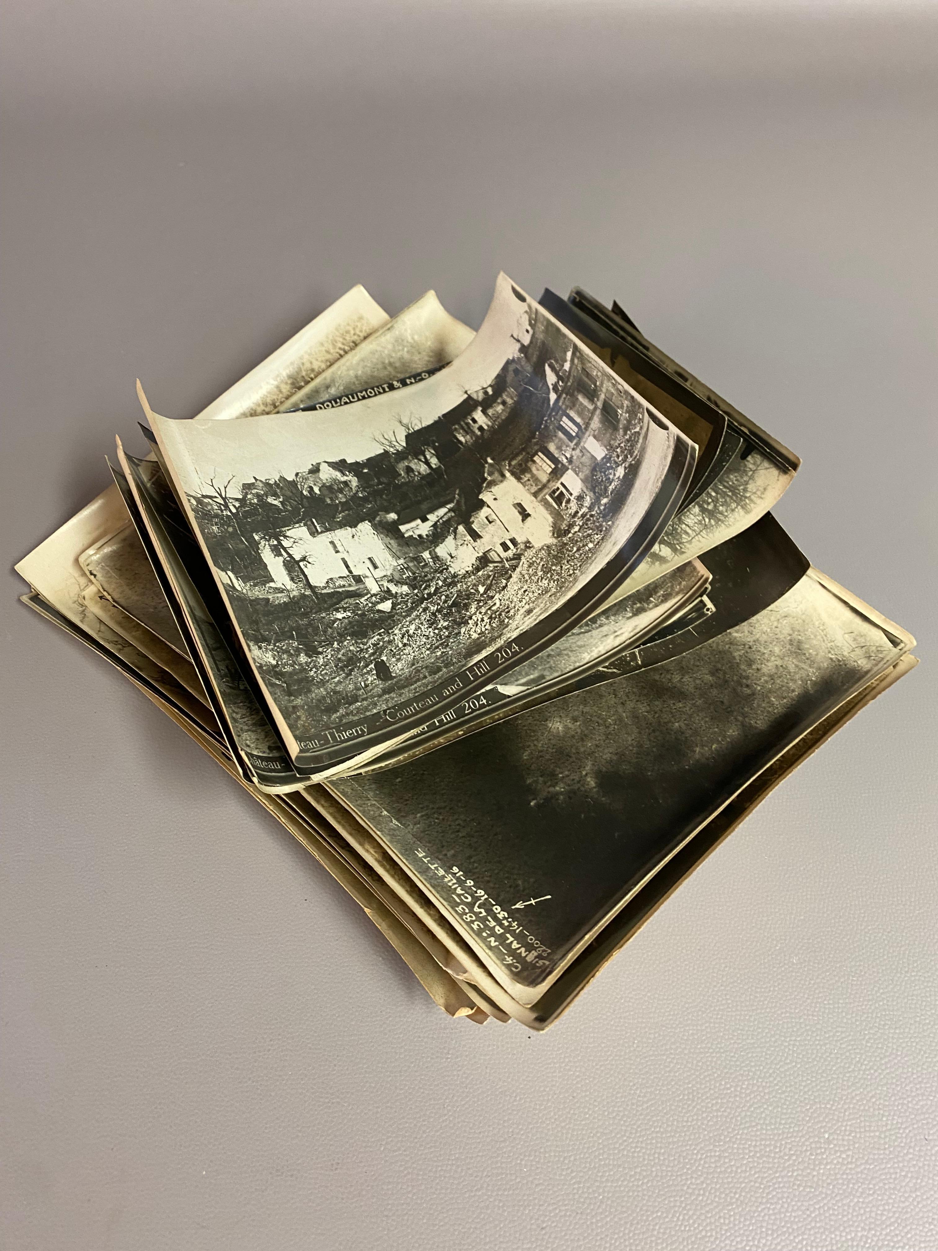 Nineteen assorted French World War I black and white aerial reconnaissance photos. Circa 1916-17. These eerie images show the senseless destruction of monuments, villages and homes, bomb craters, railings, and the hand dug trenches by the troops