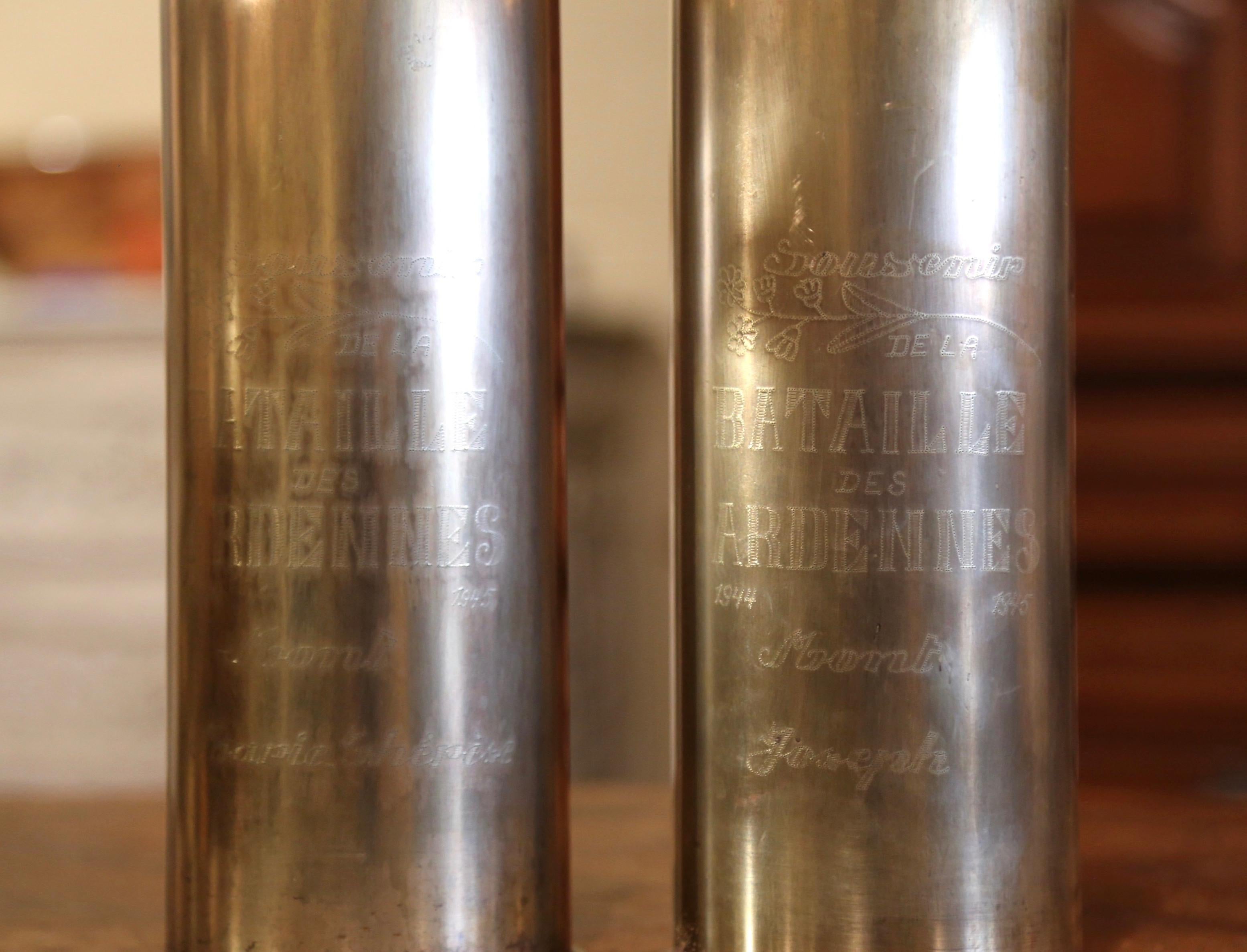 Decorate a man's office or a study display shelf with this pair of antique trench art shell vases commemorating the battle of the Bulge. Made of brass and dated 1944 on the bottom, the artillery shell casings feature the following engraved
