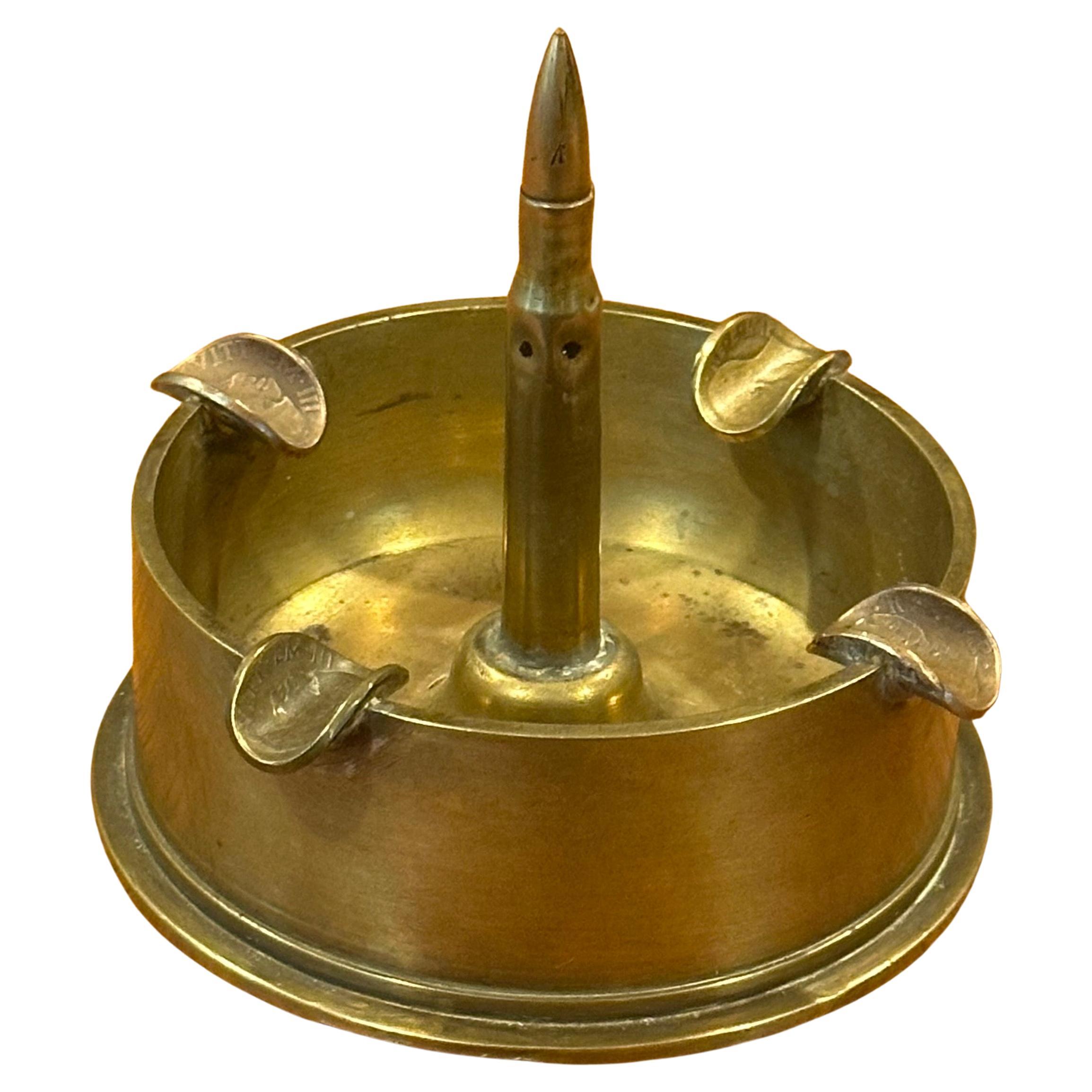 A unique military munition trench art, solid brass with coin slots ashtray, circa 1930s. The piece is in great vintage condition and measures 4.25