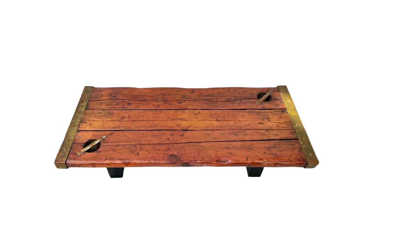 Nautical coffee table using authentic WWII ship hatch door. Thick wood top with wide metal banded ends. Wonderful old patina.  Awesome piece of maritime memorabilia.