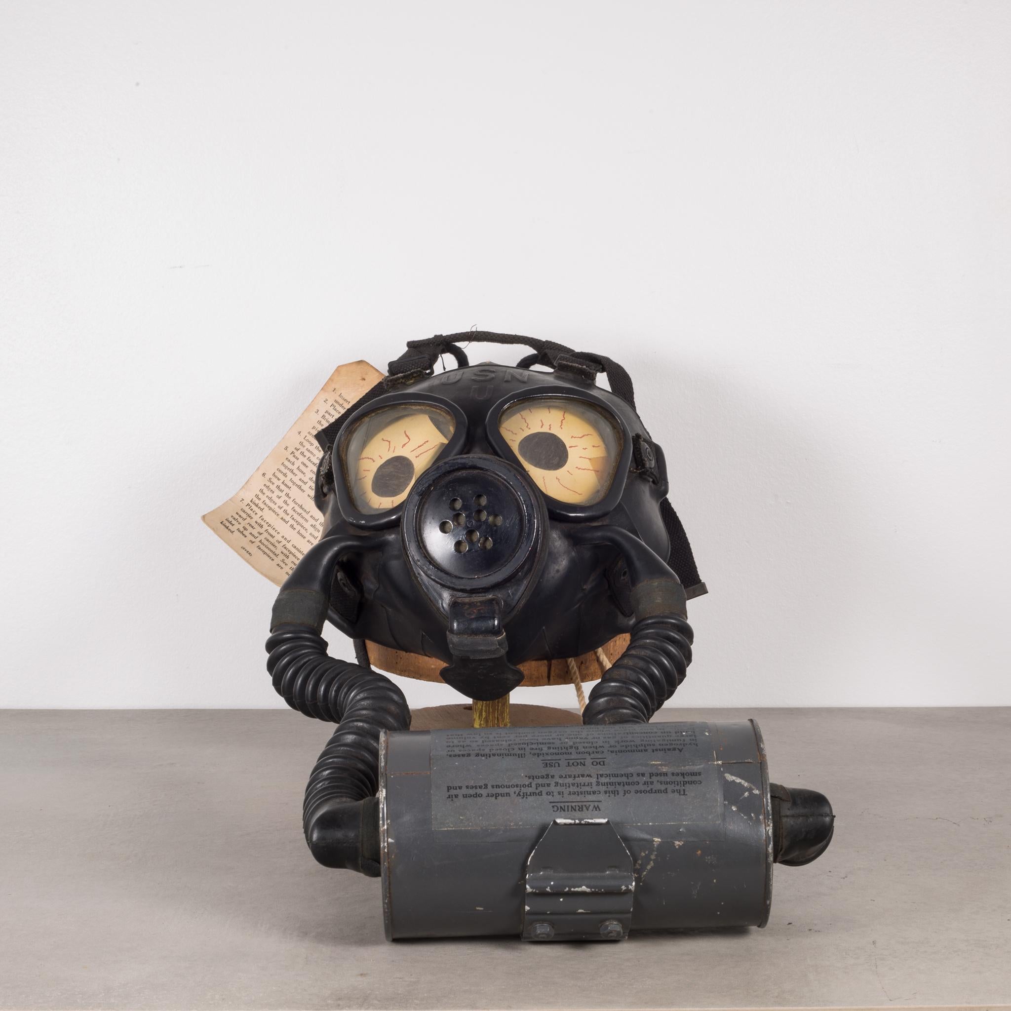 This is an original World War ll era Navy gas mask shop display with original store tag, red eye display, oxygen tank and original fabric carrying bag. The mask has retained its original finish and has the appropriate patina consistent with age and