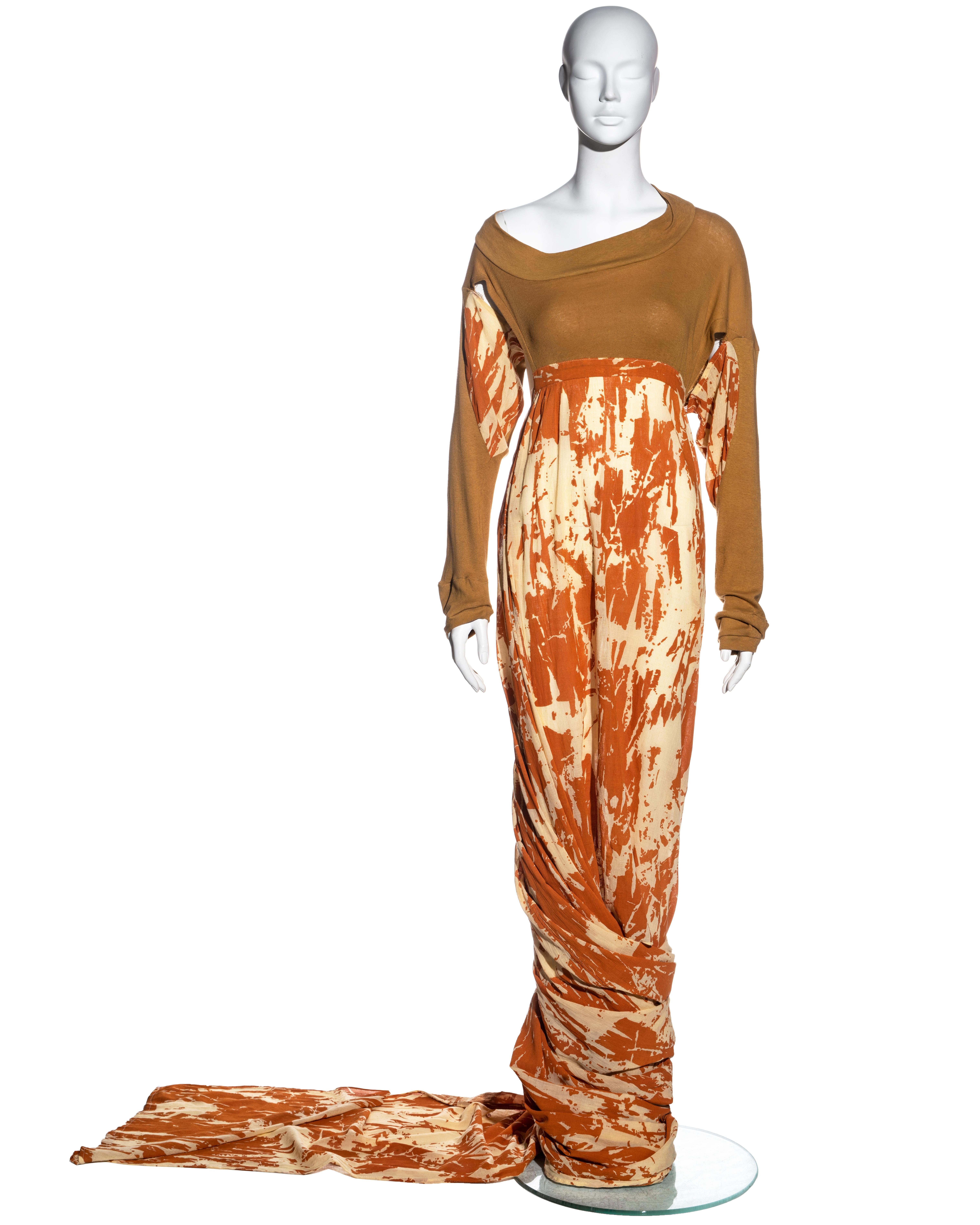 ▪ A rare Worlds End toga dress 
▪ Designed by Vivienne Westwood and Malcolm McLaren 
▪ Cotton-jersey bodice
▪ Open sides with ties to the waist 
▪ Asymmetric sleeves 
▪ Cream and orange printed floor-length skirt with long train which can be styled