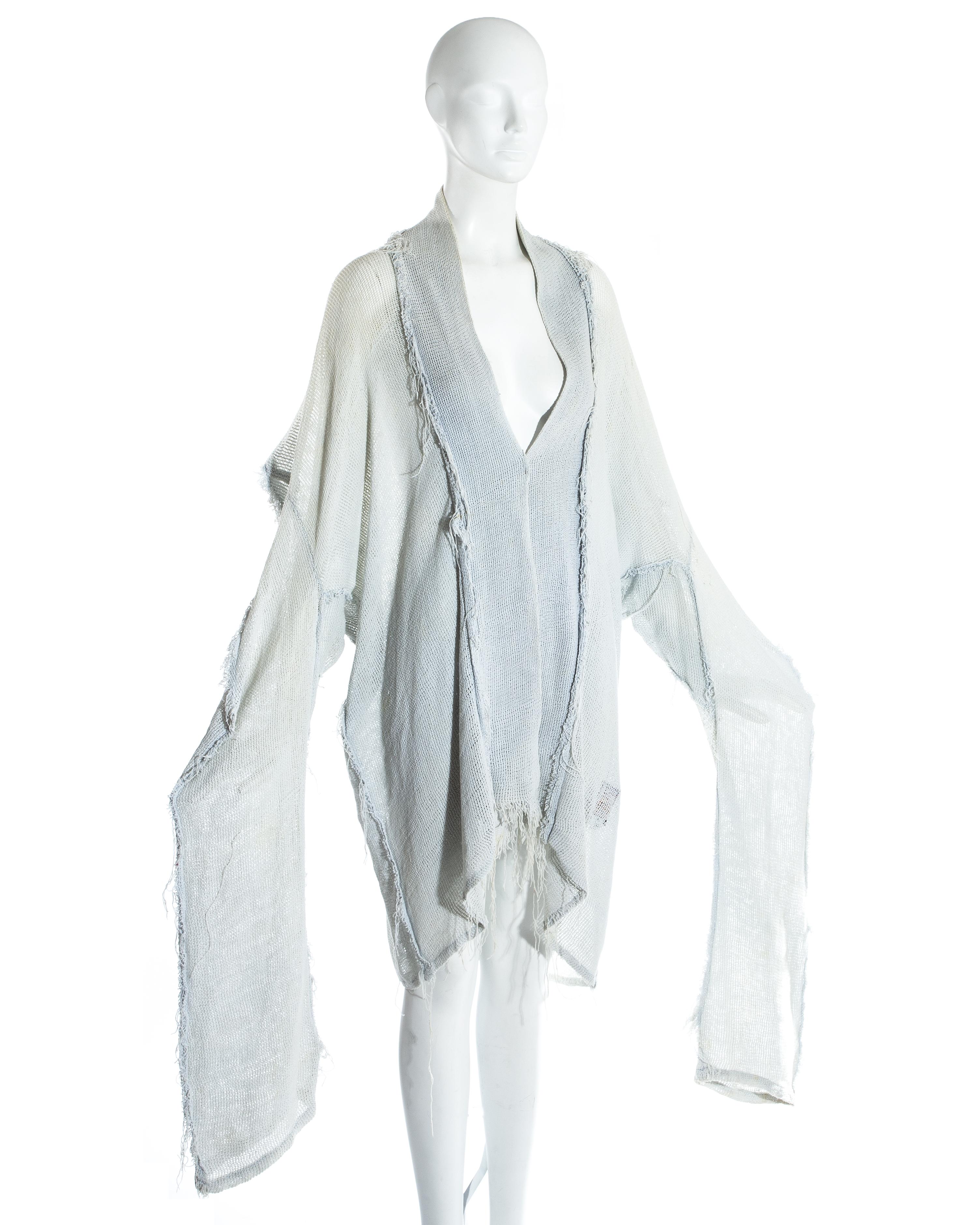 Worlds End by Vivienne Westwood and Malcolm McLaren; Oversized dove grey cotton gauze jacket. Extra long sleeves, inverted frayed seams and square cut shoulders. Worn open with no closures.

'Punkature', Spring-Summer 1983