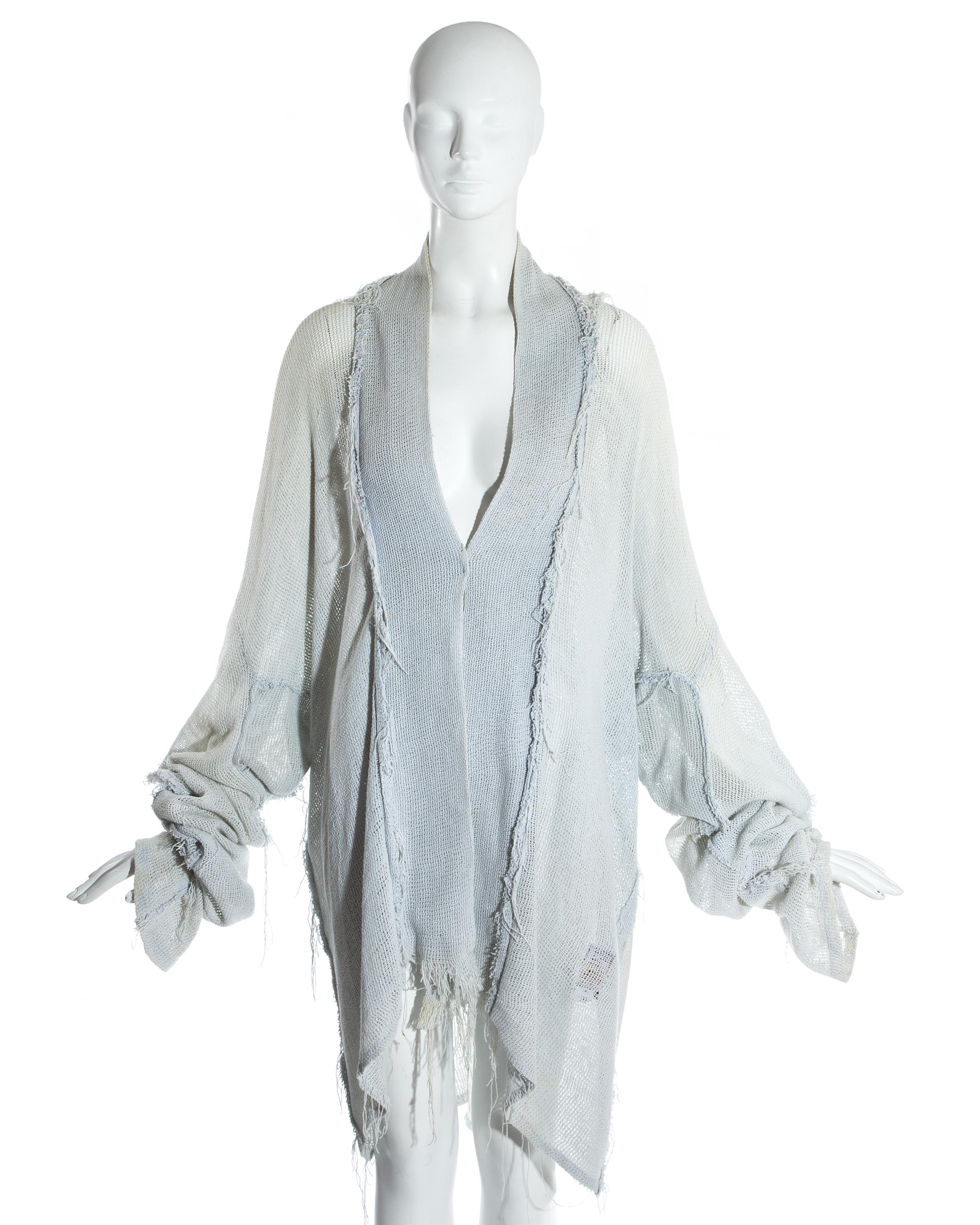 Worlds End by Vivienne Westwood and Malcolm McLaren; Oversized dove grey cotton gauze jacket. Extra long sleeves, inverted frayed seams and square cut shoulders. Worn open with no closures. 

'Punkature', Spring-Summer 1983 