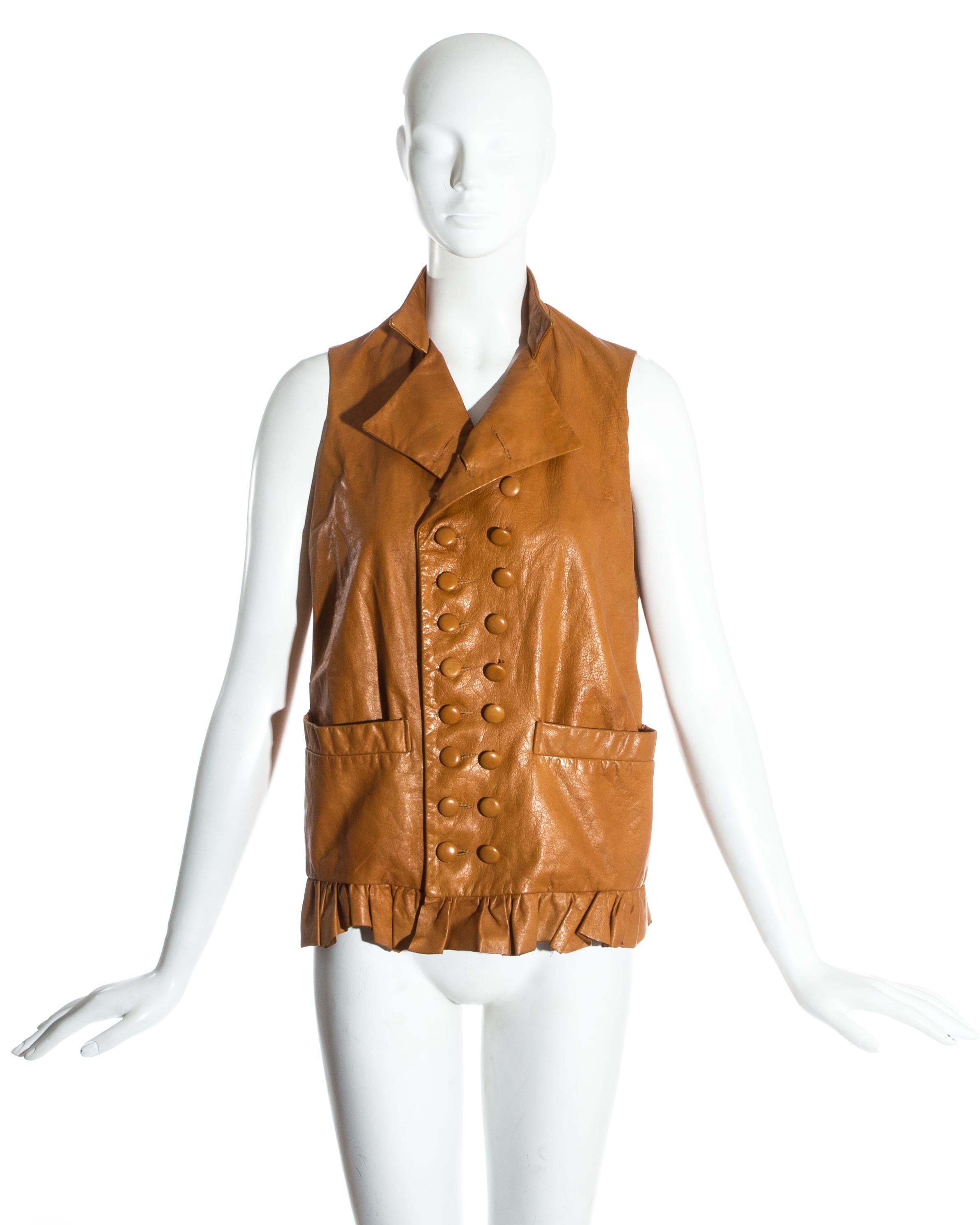 Worlds End by Vivienne Westwood and Malcolm McLaren. Unisex tan leather double breasted waistcoat. Mandarin collar, ruffled hem with raw finish, matching leather buttons and cream cotton lining.

Pirates, Fall-Winter 1981