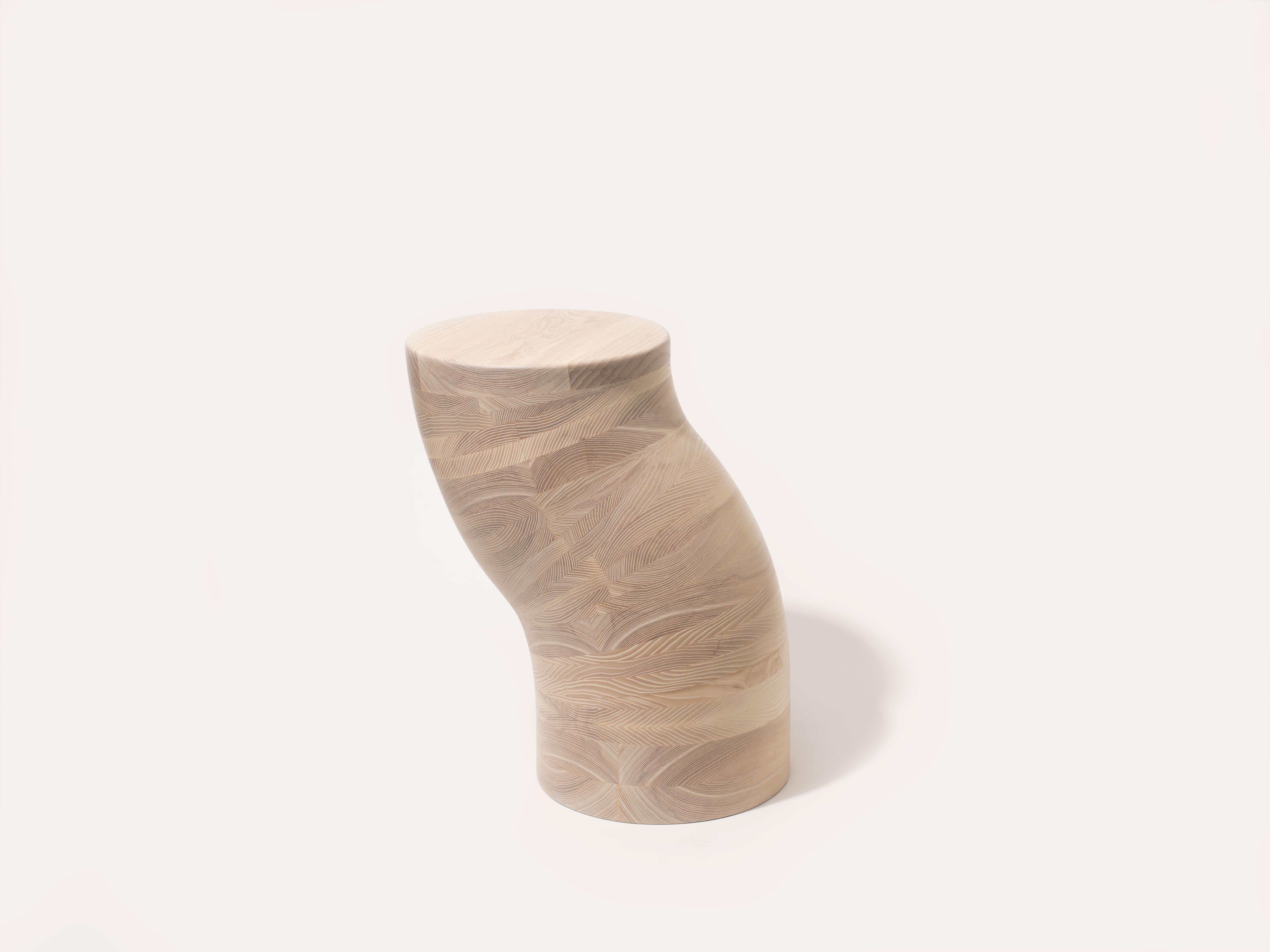 The worm side table is handcrafted out of solid Ash. The Worm Side table is built by laminating tapered layers of ash, then hand carving into shape. Each Worm is unique as each has it's own curvature and wiggle. The base is weighted to aid in