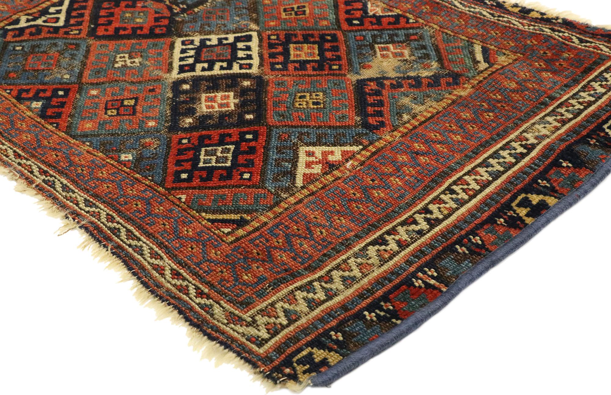 76608, worn antique Caucasian Kazak rug with tribal style, small Persian rug. With its perfectly worn-in charm, pop of color and edgy elements, this antique Caucasian accent rug will create a warm, lived-in look and take on a curated look that feels