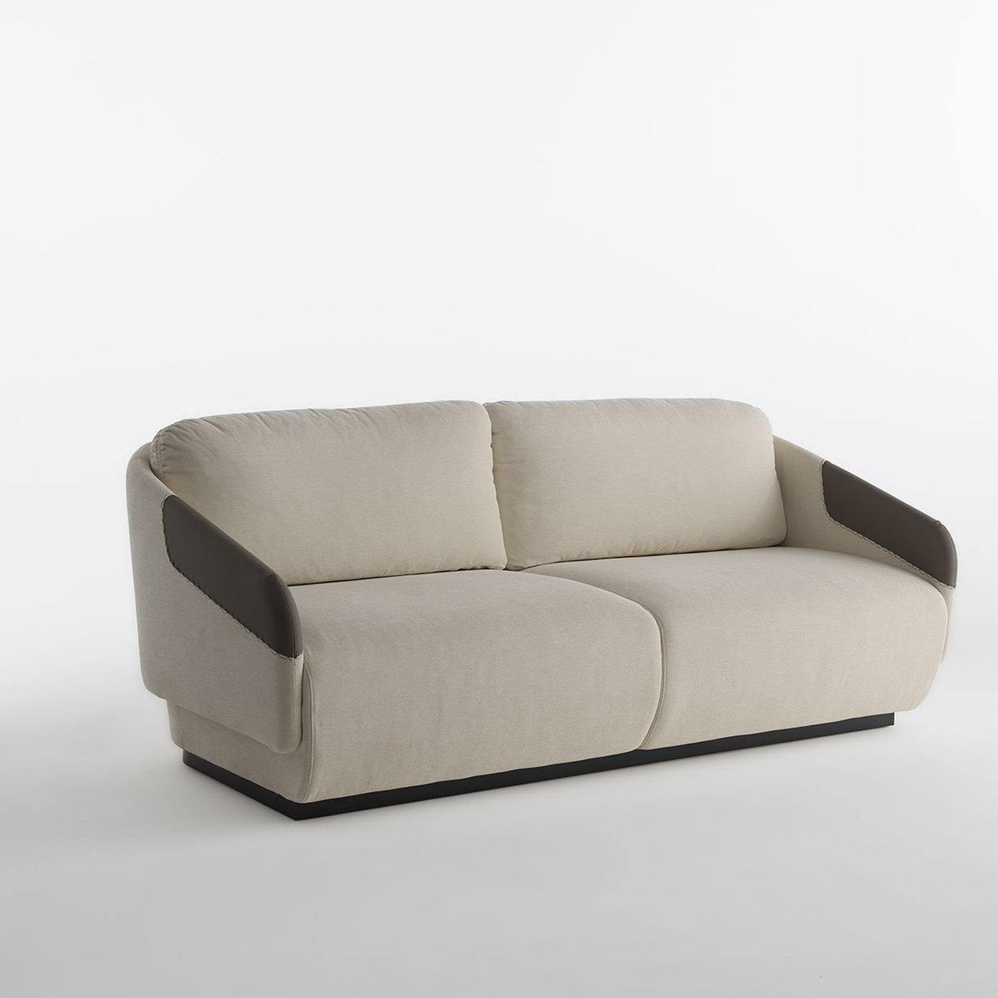 Part of the Worn collection, this two-seater sofa's essential silhouette and tailored details make it an absolute statement addition to a modern living room. The metal structure, reinforced with elastic belts, is padded with high-density