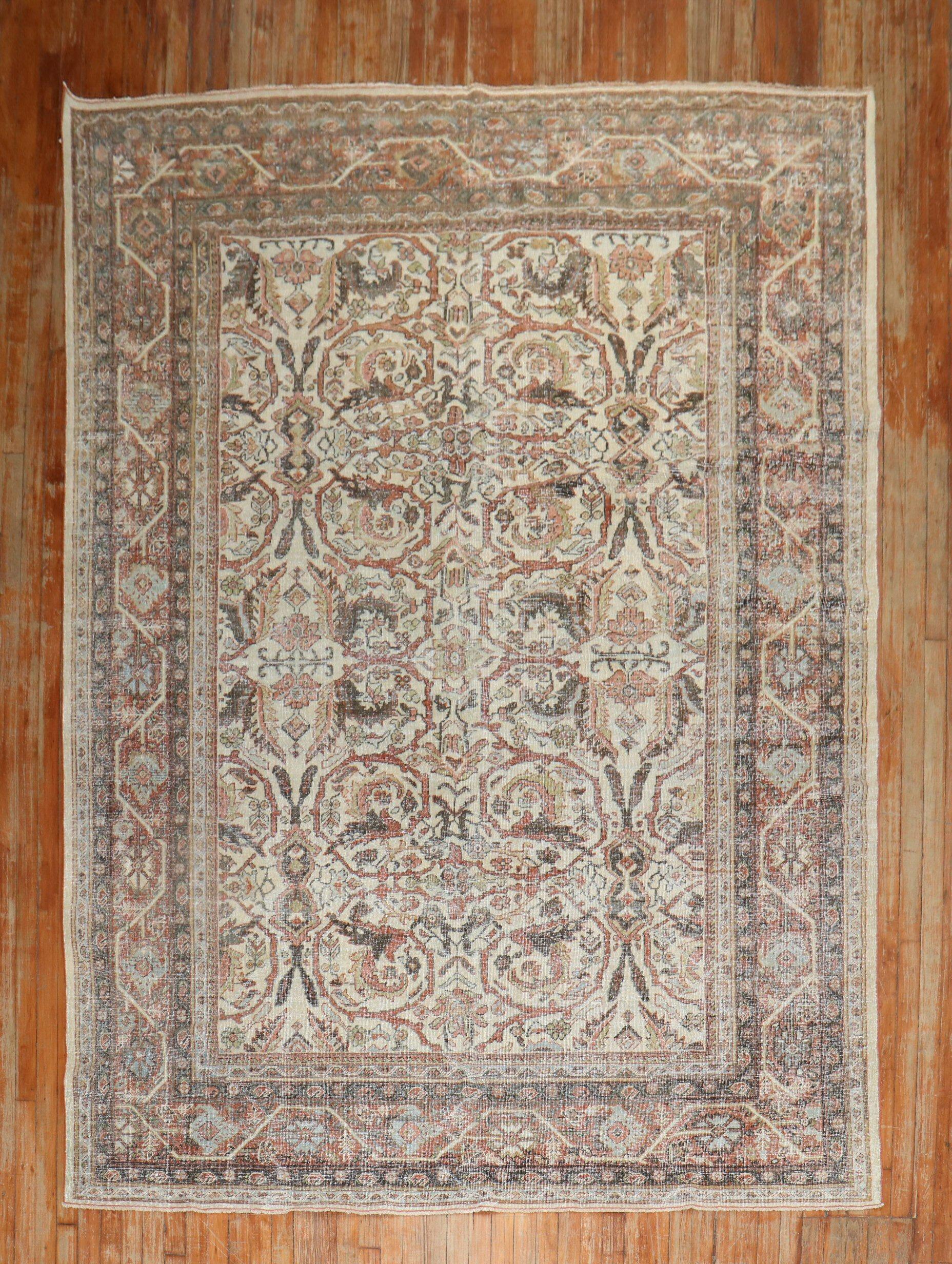 A one-of-a-kind Persian Mahal worn rug featuring an ivory ground with a bold, masculine pattern from the 1st quarter of the 20th century

7' x 10'2