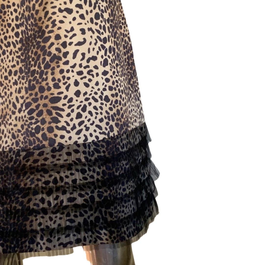 The W label for Worth NYC designed a playful and chic leopard skit in a cotton/poly leopard print. The sophistication comes in with a beautifully pleated black netting that makes the 4 layer ruffle hem. The waistband is also covered with the black