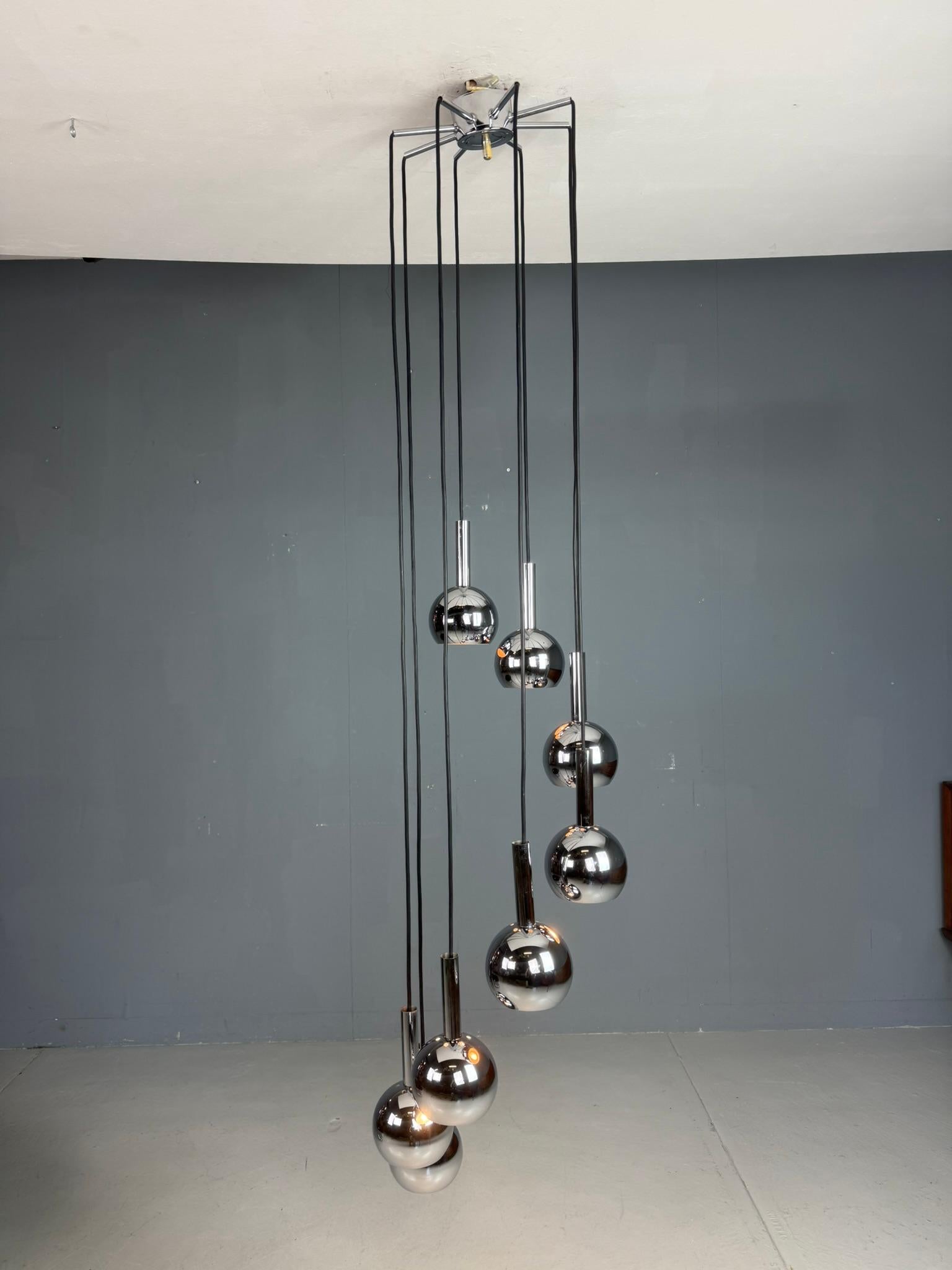 Stunning Space Age cascading ceiling lamp from the 1970s, featuring 8 metal shades in a sleek, futuristic design. This iconic piece captures the essence of the Space Age era, with its clean geometric shapes and chrome metallic finish, evoking the