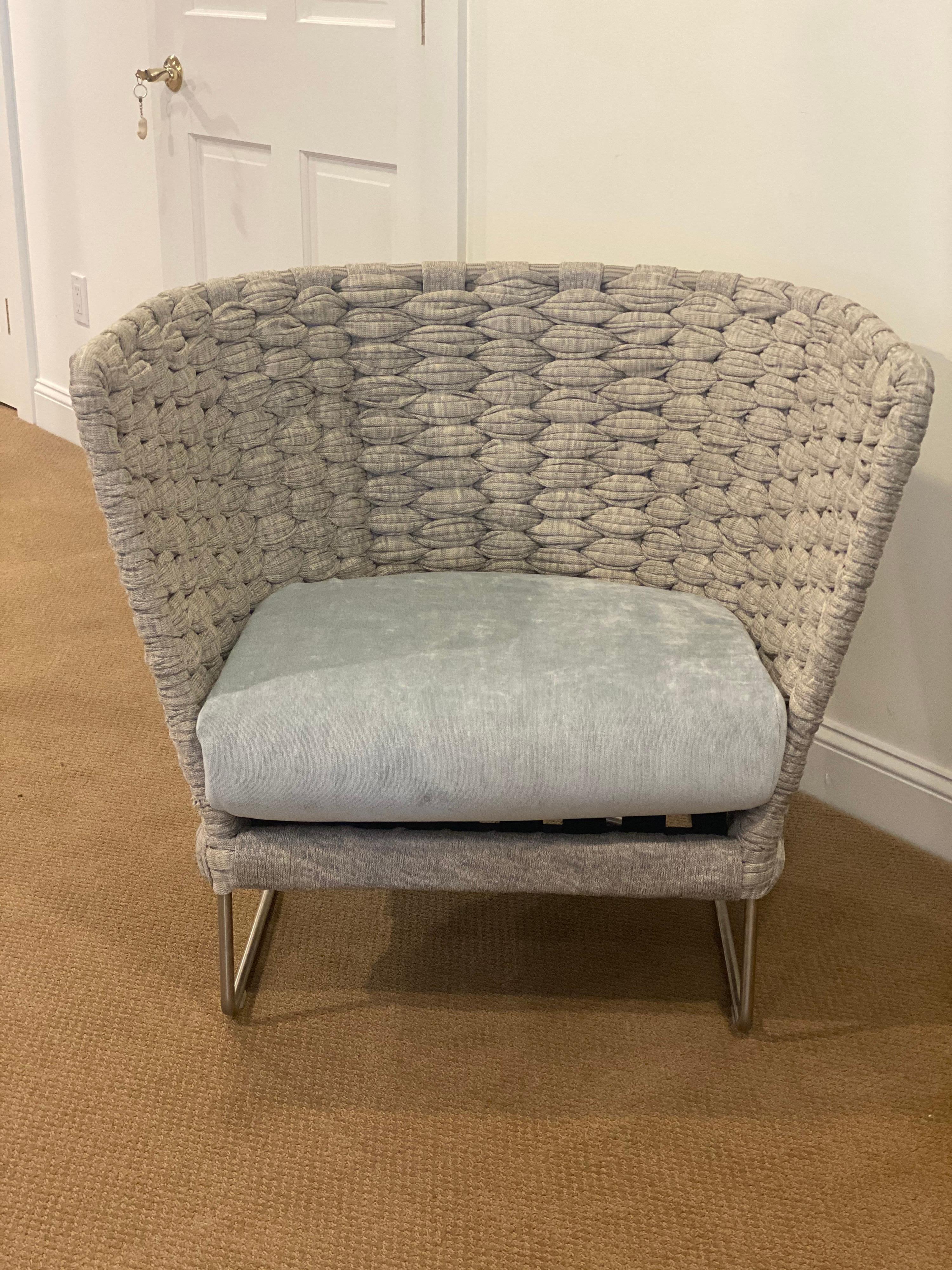 Woven Barrel AMI chair by Paola Lenti, Italian.
Stainless steel base, woven heather grey weaving. Seat covered in grey velvet. 
Measures: 32” deep x 33.5” wide x 17” SH x 30.25” high.