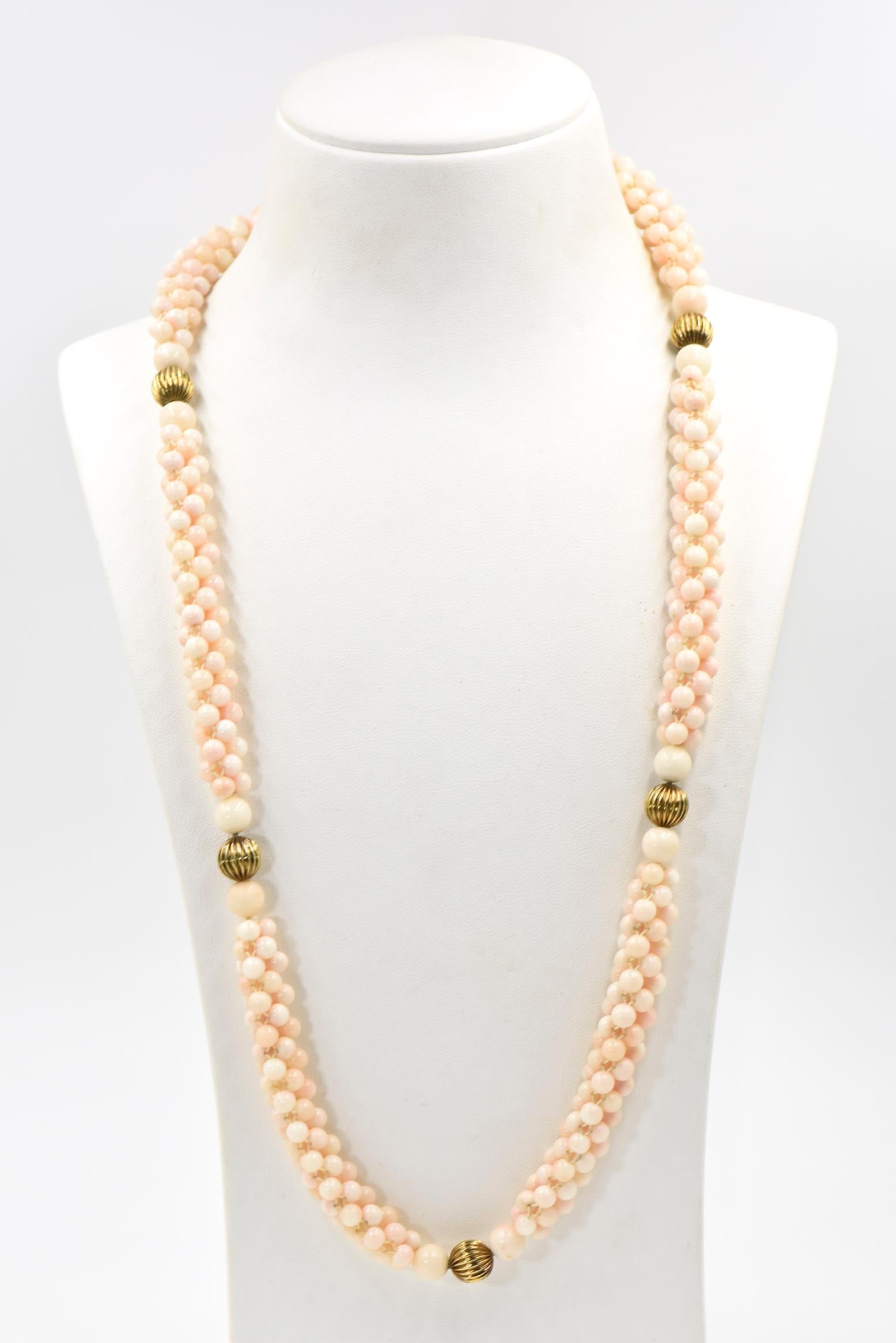 Finely woven light pink angel skin coral beads with ribbed 14k yellow gold bead accents and a tubular 14k matte and shiny finished clasp.  The clasp has 2 balls you line up and then twist to close and open the pieces. The small coral beads are