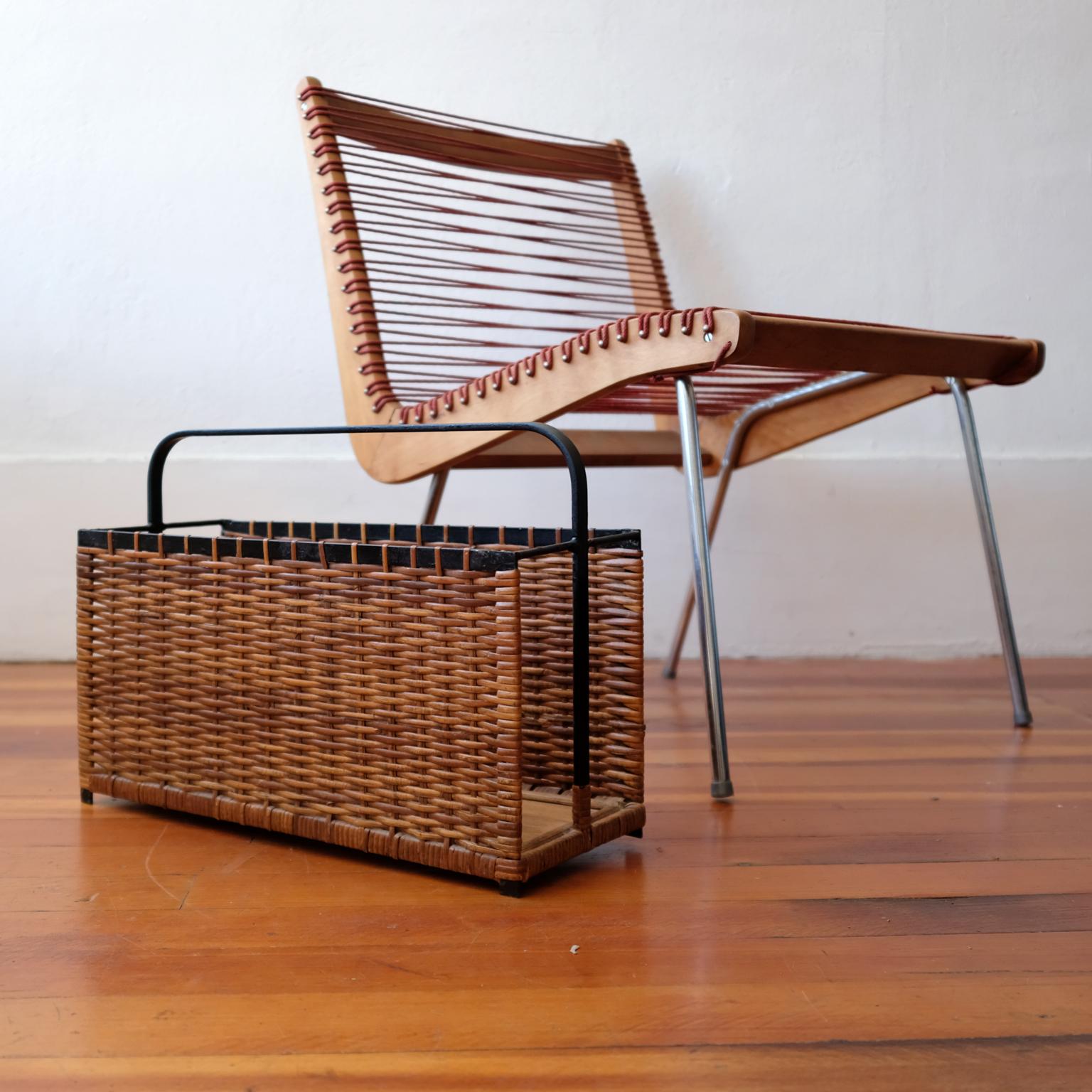Woven cane and iron magazine holder from the 1950s.