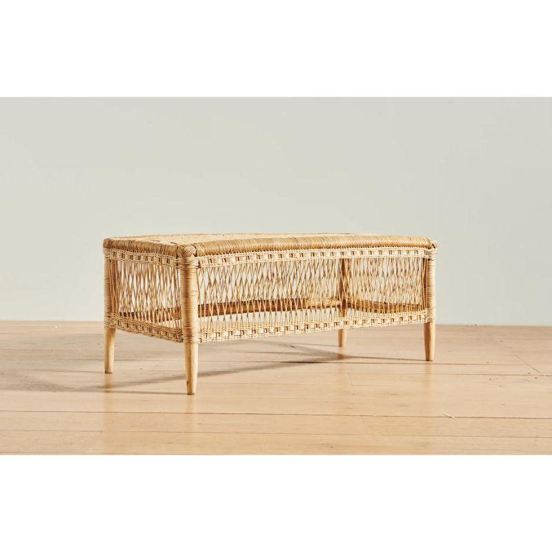 Center your common space around this functional, meticulously detailed bench. Its combination of woven cane and solid wood legs can be easily incorporated into nearly any setting, from serene and minimal to artfully cluttered and colorful, or