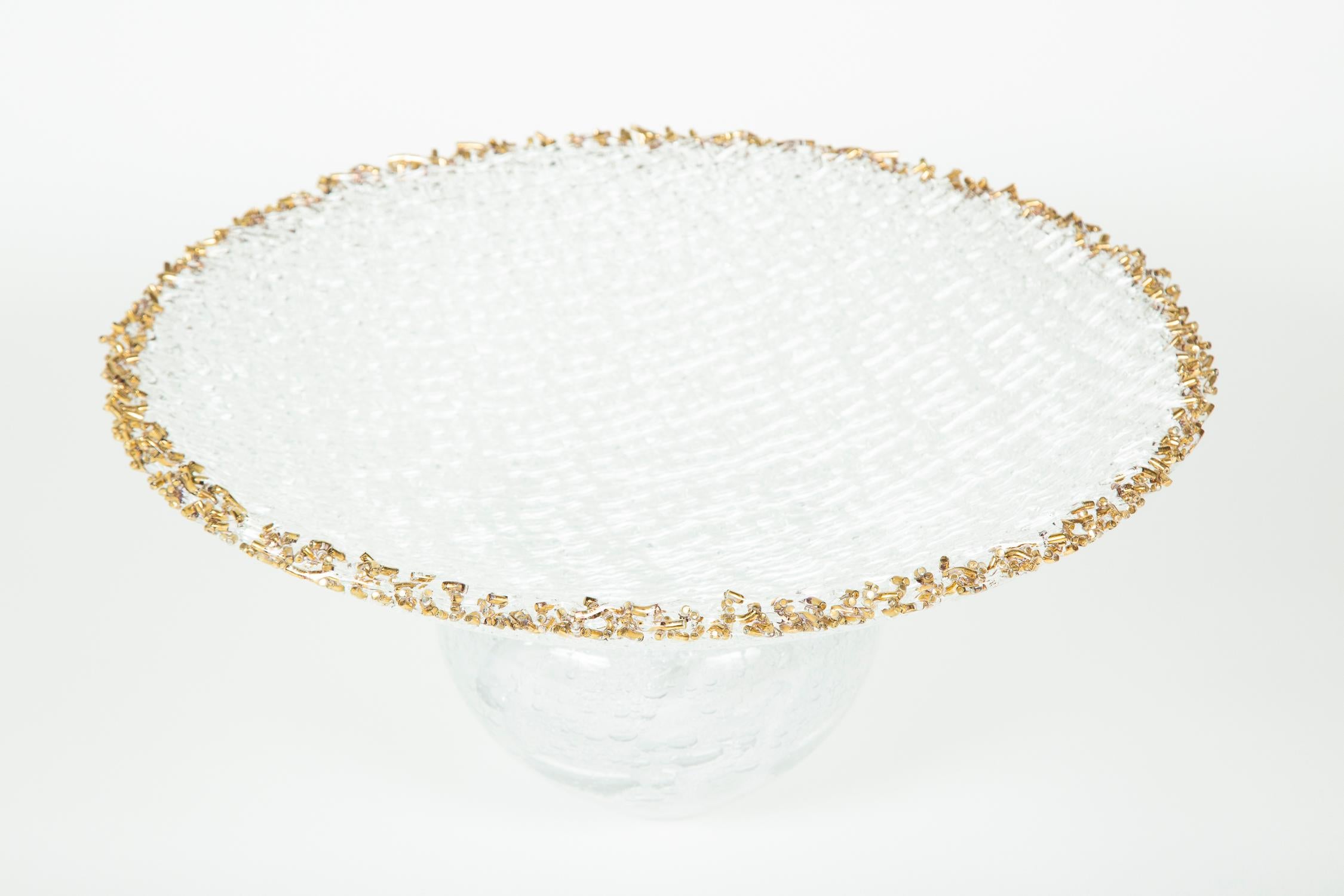 Woven Chalice is a unique clear glass centrepiece / sculpture by the British artist Cathryn Shilling. Using her signature woven glass 'fabric' technique, Shilling layers kiln formed glass cane to create the raised main dish, which is finished with a