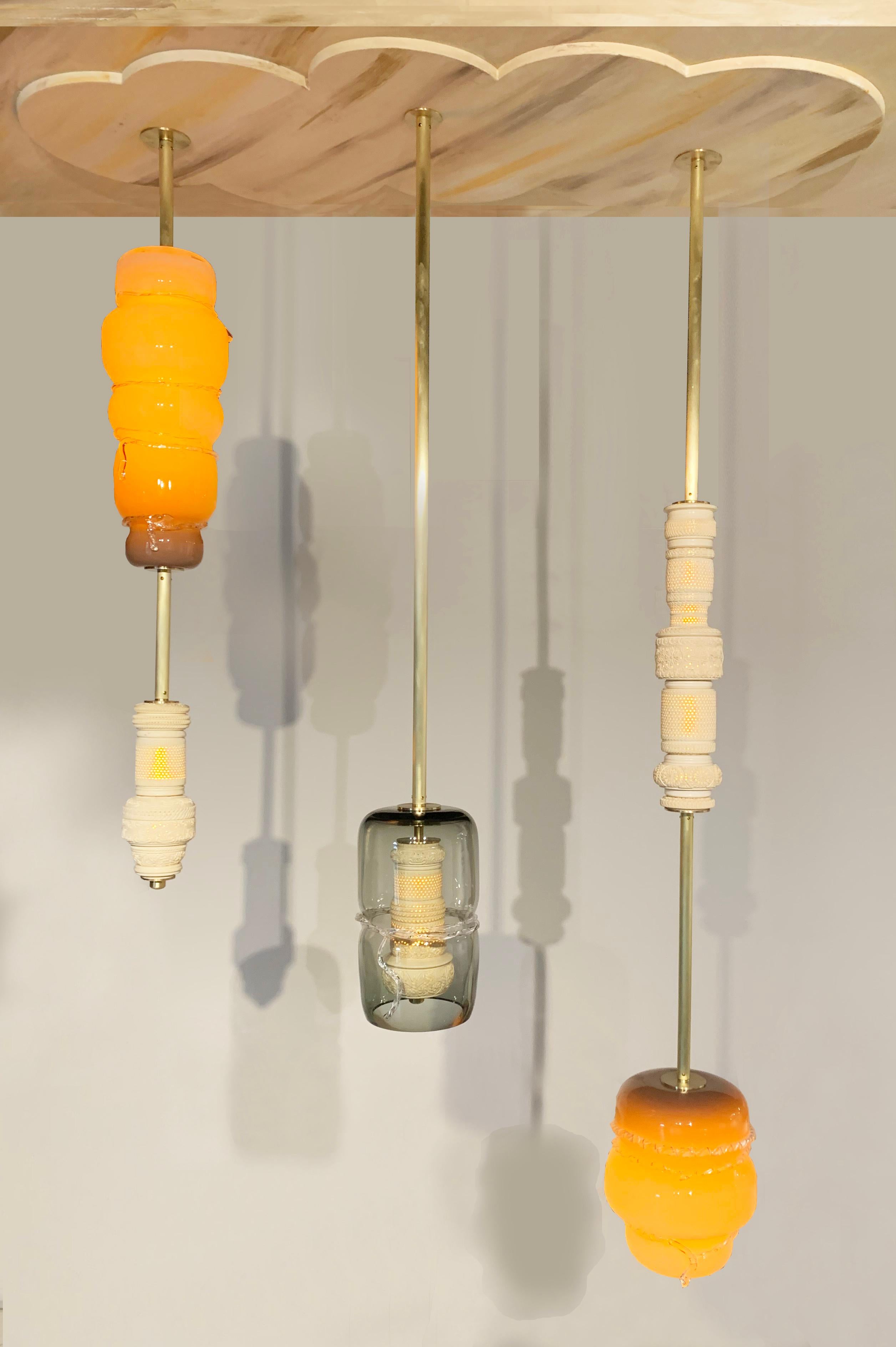 Feyza Kemahlioglu
Woven Colony, 2019
Meershaum, blown glass, brass, wood and LEDs
Pendant 1: 30 x 7 x 7 in
Pendant 2: 44 x 10 x 10 in
Pendant 3: 48 x 14 x 14 in

Created by Feyza Kemahlioglu of FEYZ Studio, this chandelier of three pendants is