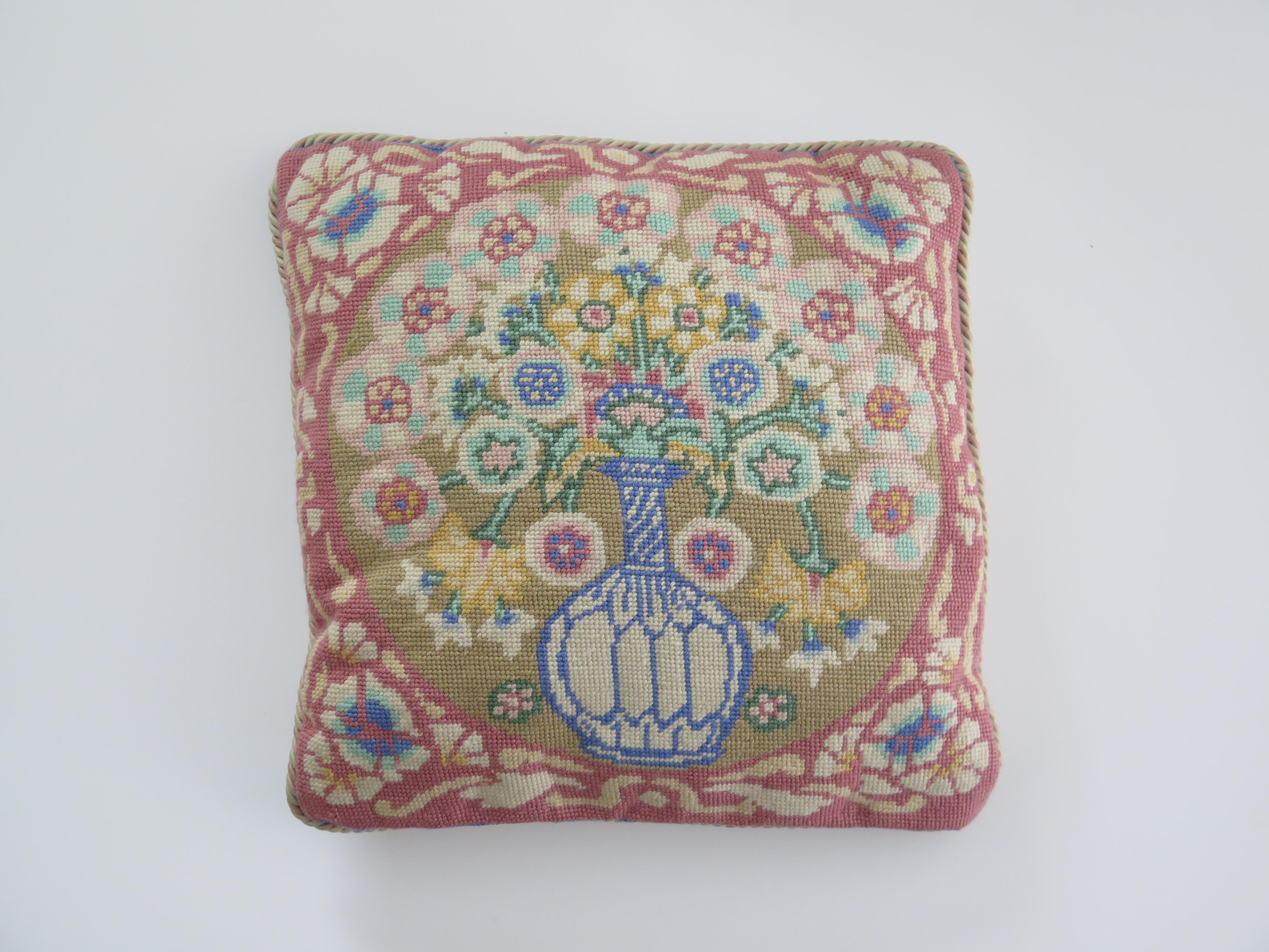 This is a very attractive woven pillow or cushion with a country floral style, which we date to circa 1930s of the 20th century.

The floral themed design depicts a blue vase holding different coloured flowers, all in soft pastel shades, with colors