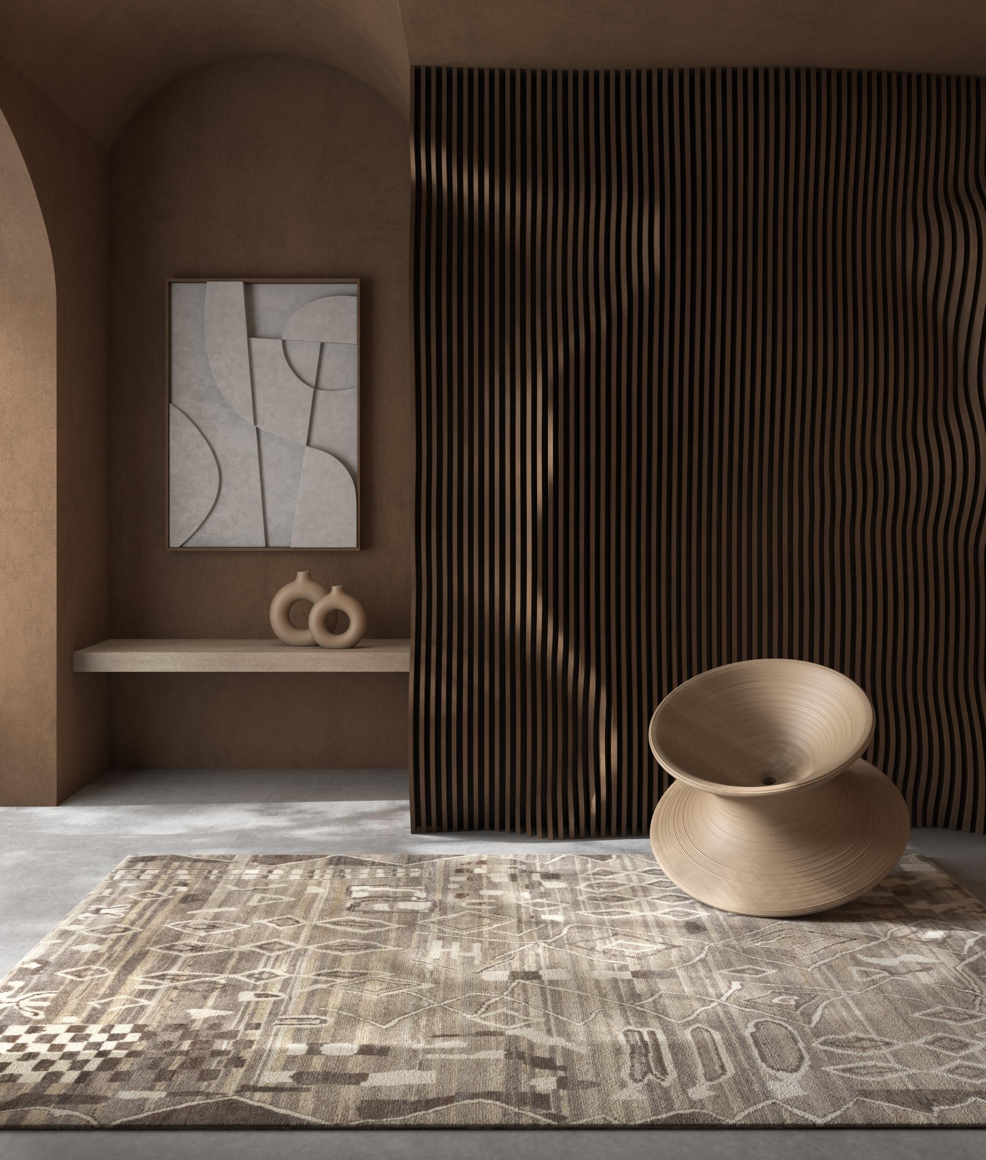 Ce tapis moderne en laine est un mélange captivant de motifs éclectiques et d'élégance naturelle, noué à la main au cœur de l'Inde rurale à l'aide de la meilleure construction entièrement en laine. Ce superbe tapis présente un fond gris naturel,