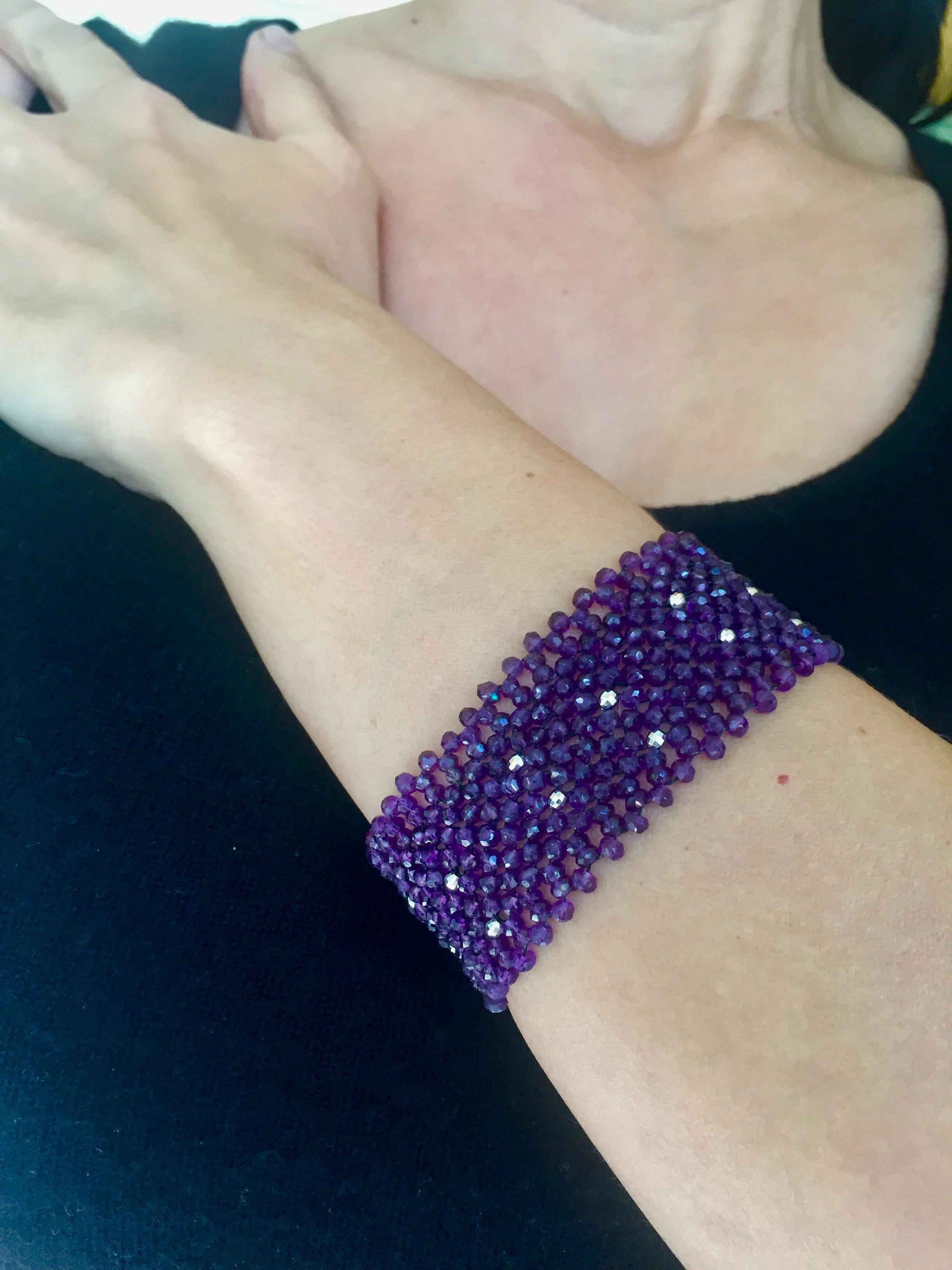 The woven faceted amethyst cuff bracelet with sterling silver clasp and beads is a beautiful shade of deep purple. At 1.25 inches wide and 7.15 inches long this bracelet gracefully drapes the wrist. The rhodium-plated silver beads twinkle throughout