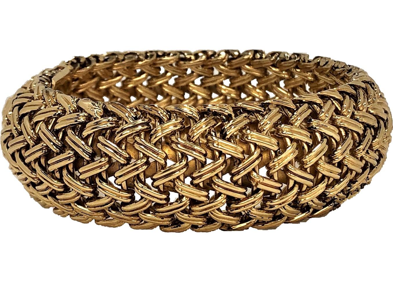 A smart looking, 14 karat gold Bombe bracelet featuring a woven design. 
Measuring 7 1/2 inches long by 7/8 inch wide with a figure 8 safety clasp 
on one side.  Marked 14K. Gross weight 74.6 grams.