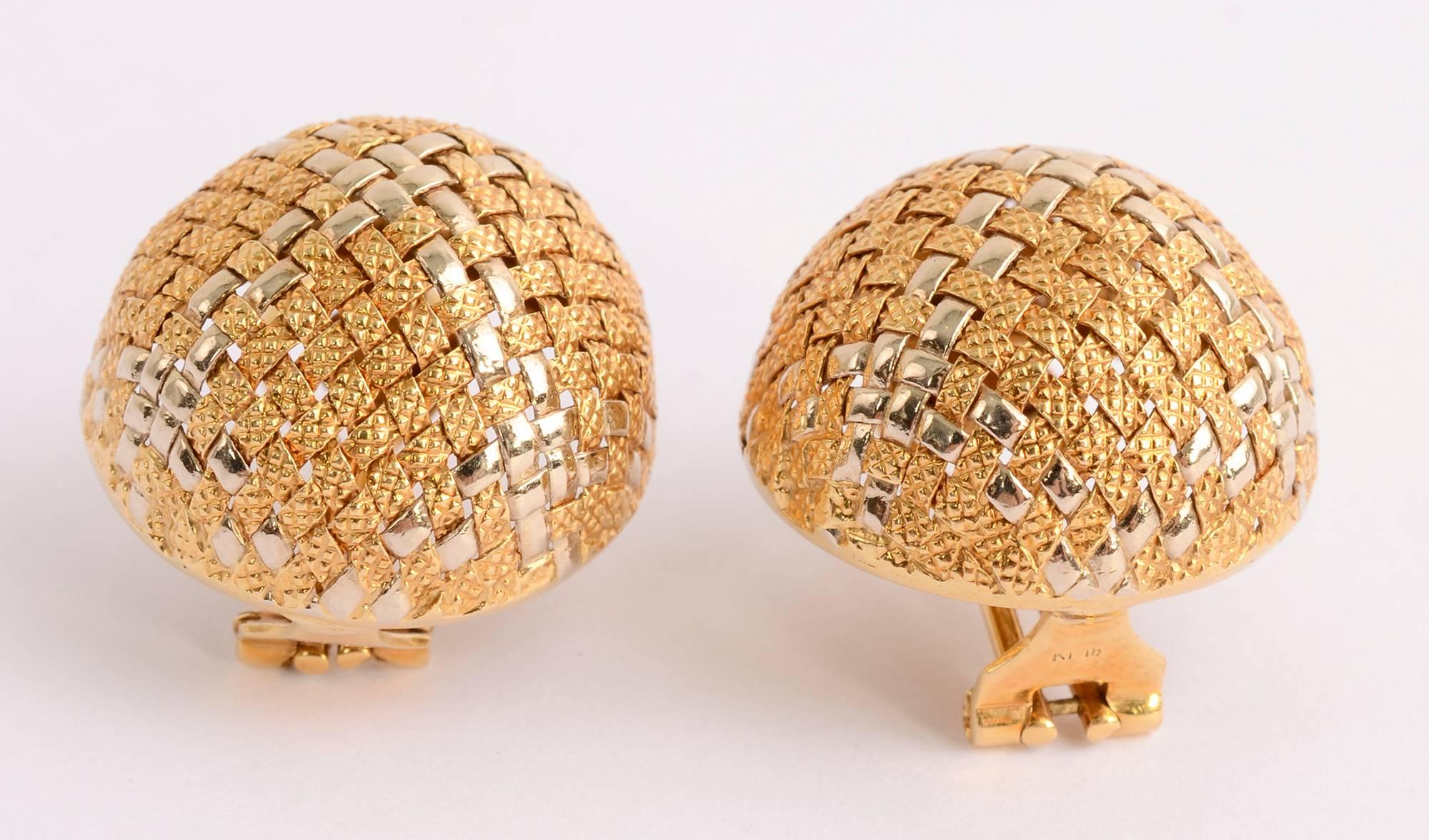 Finely woven dome shaped earrings with two different colors of gold. The glossy strips are a pale yellow while the textured strips are a slightly darker tone. The earrings measure 1 inch in diameter. Backs are posts and clips.