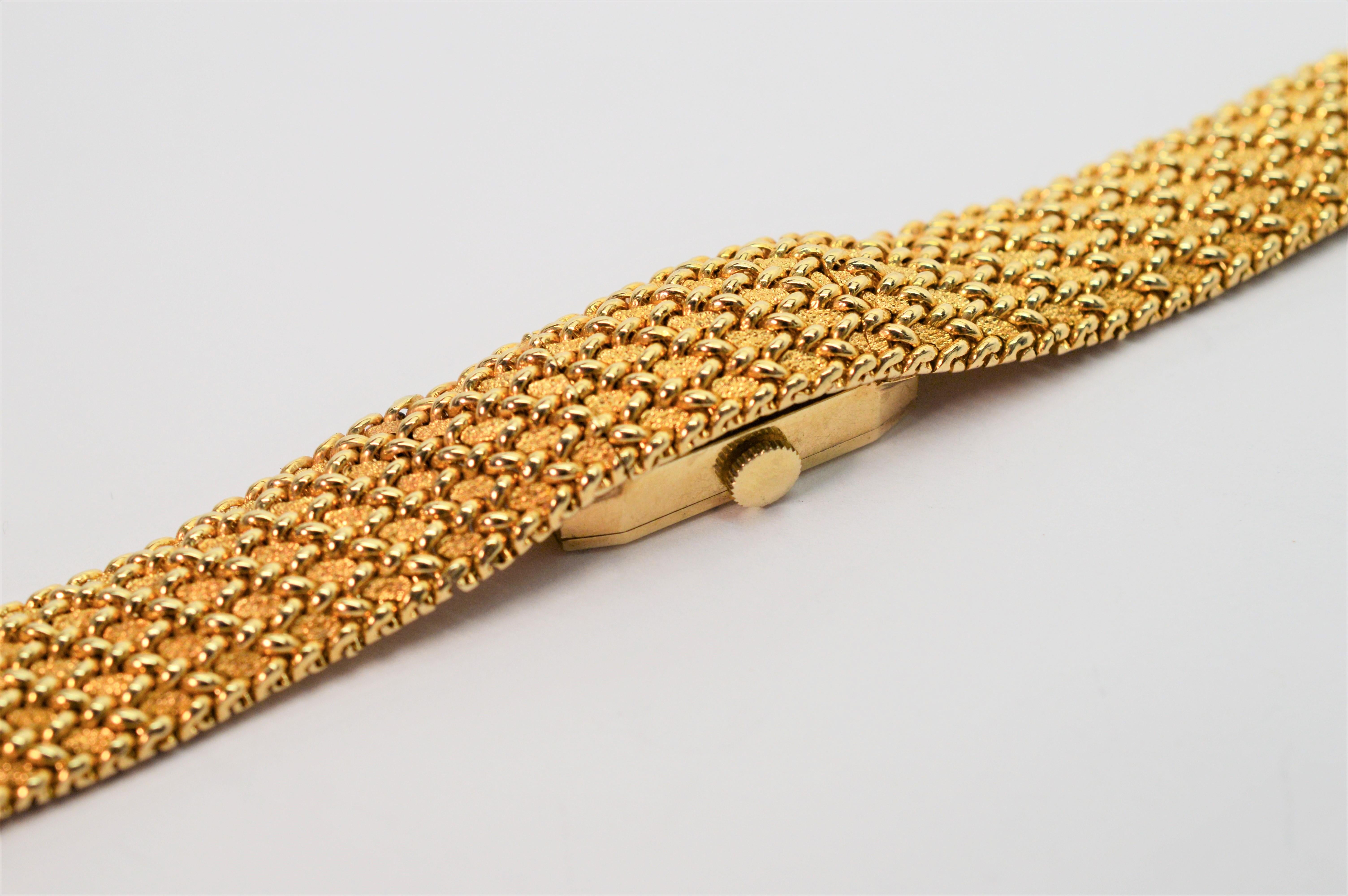 Wear the time with true elegance. A fine woven gold mesh bracelet in fourteen karat yellow gold makes an elegant piece to accessorize for any occasion. Intricately integrated into this smart looking bracelet is a hidden watch by Swiss luxury