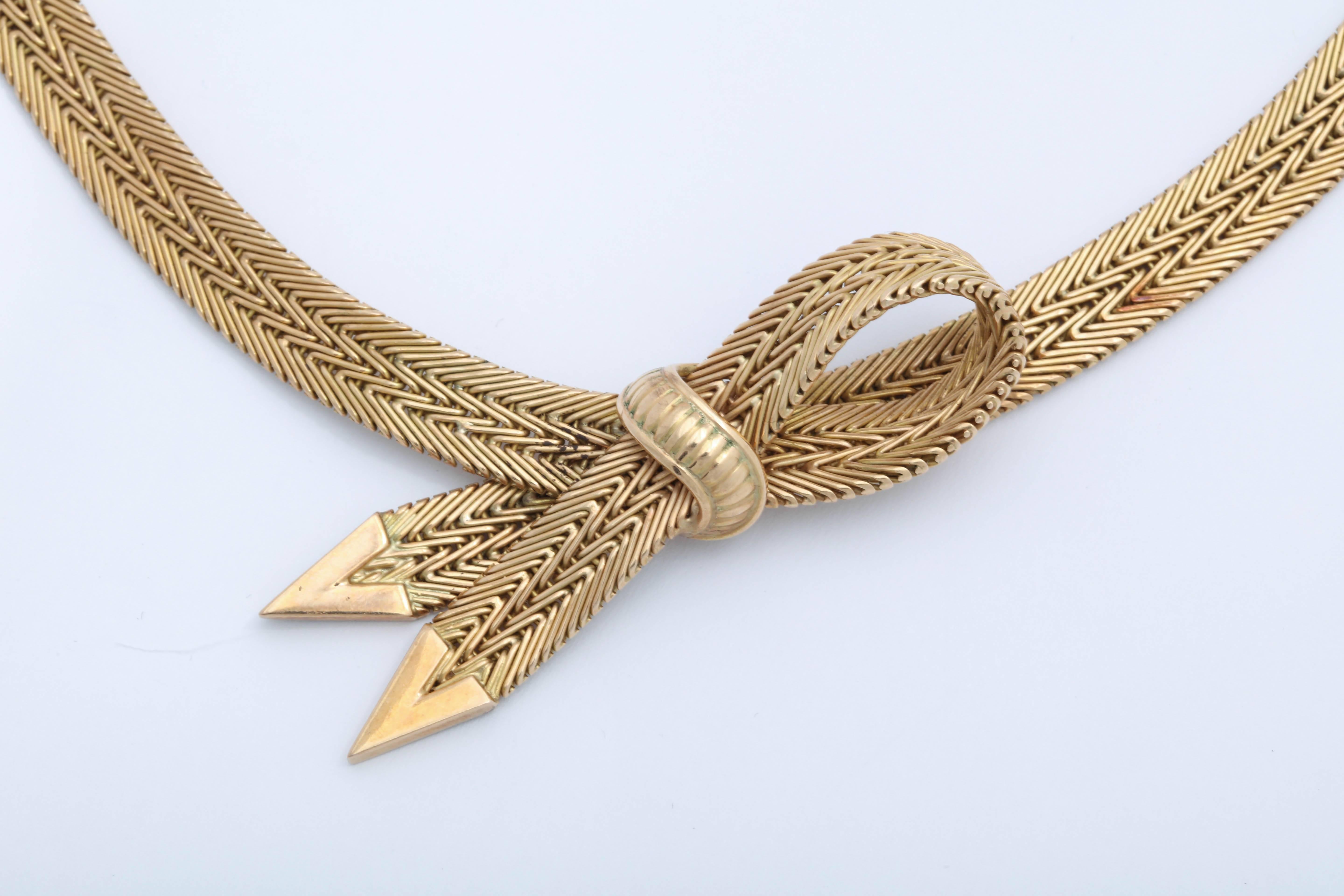 18kt Yellow Gold woven Necklace with center Bow and Box clasp closing and figure 8 safety.  Marked 750 & 18kt and an indistinct Signature.  Possibly Argentina.  Very elegant ribbon like form translated into woven Gold.