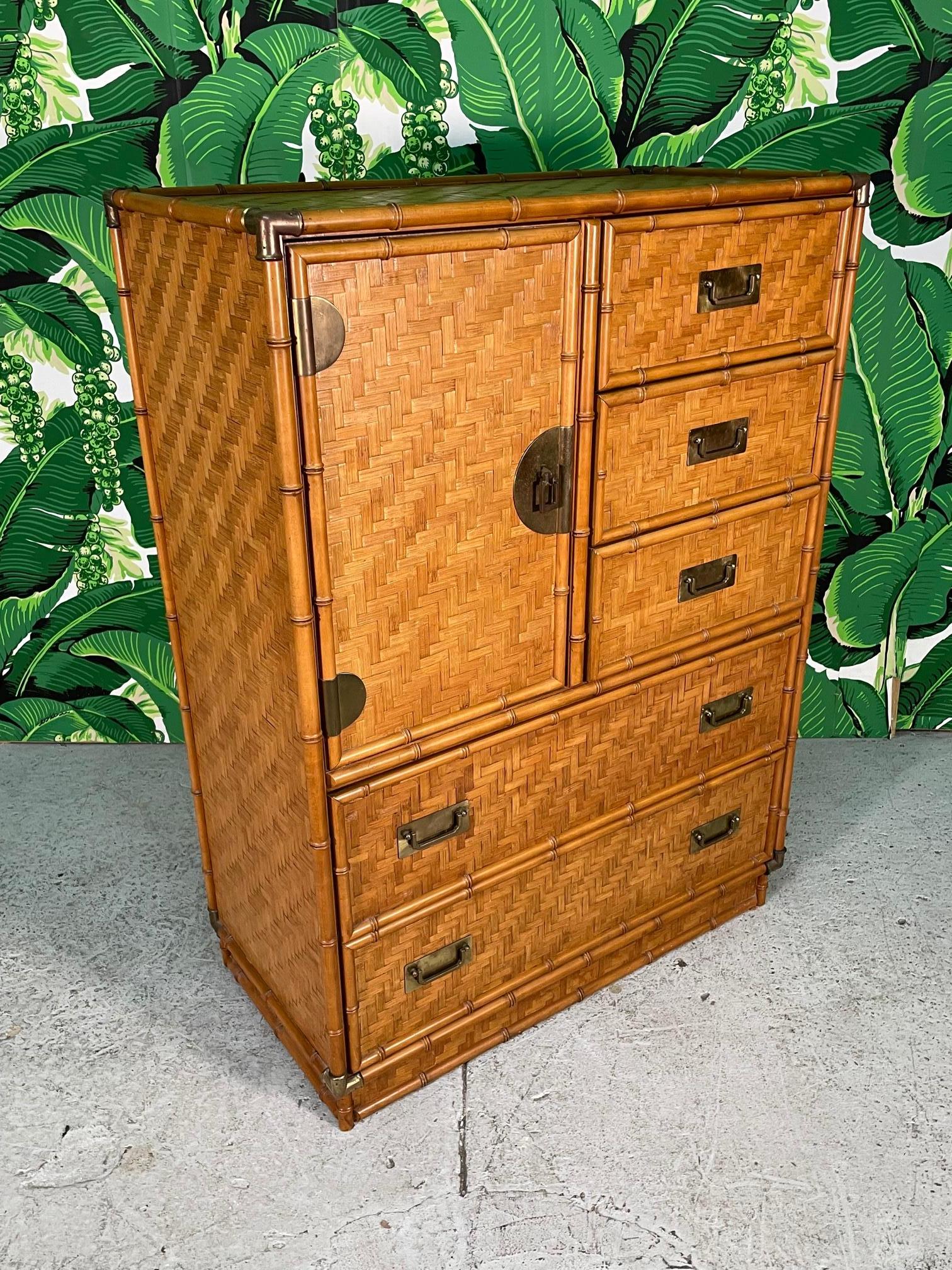 Vintage gentleman's dresser features faux bamboo detailing and a complete veneer of woven rattan basket weave in a herringbone pattern. Brass hardware and corner accents. The unique rattan veneer gives a look of parquet. Warm, rich tone throughout.