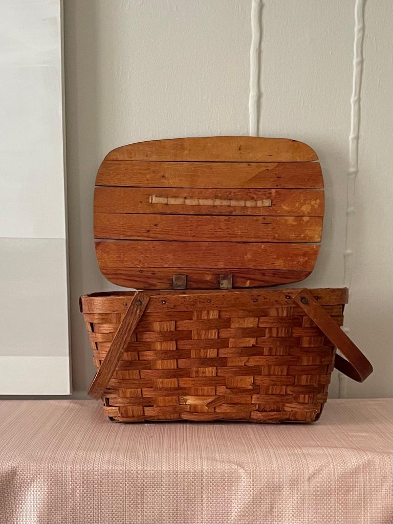 Vintage woven picnic basket with solid lid on hinge and handles

This basket is a classic shape and texture and would be a great 