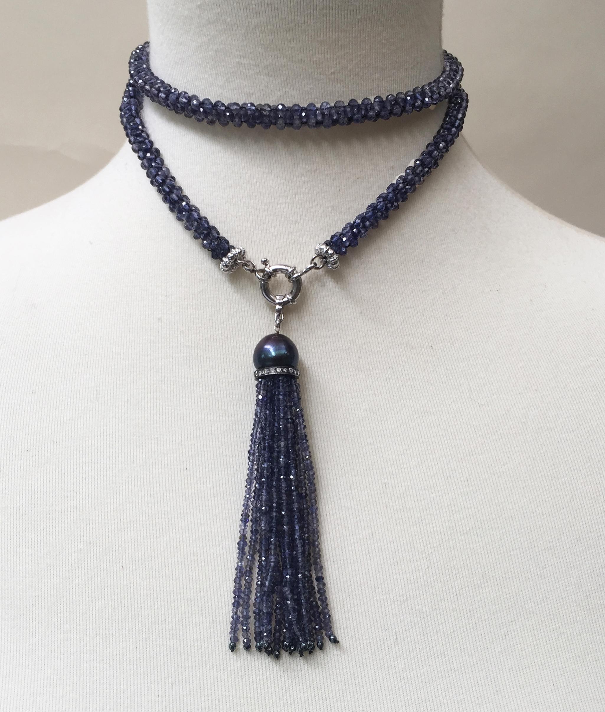 This gorgeous woven iolite sautoir and tassel with a black pearl has a 14k white gold clasp and sterling silver roundels. The faceted iolite catches the light, creating a beautiful blue hue that complements the black pearl of the removable tassel.