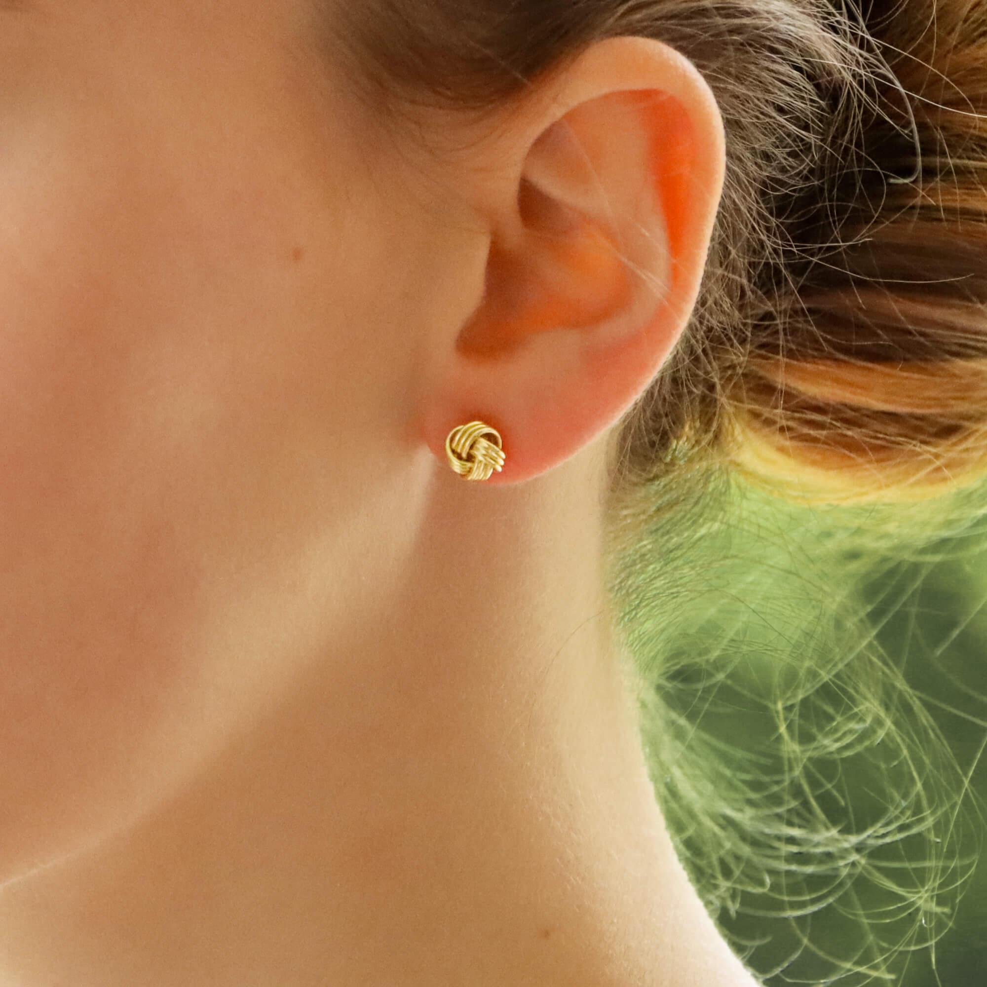 An elegant pair of knot stud earrings in 18k yellow gold. These beautifully hand crafted earrings consist of 3 strands of yellow gold woven into a simple knot.

Due to the design and size, these earrings would make a perfect everyday pair of studs.