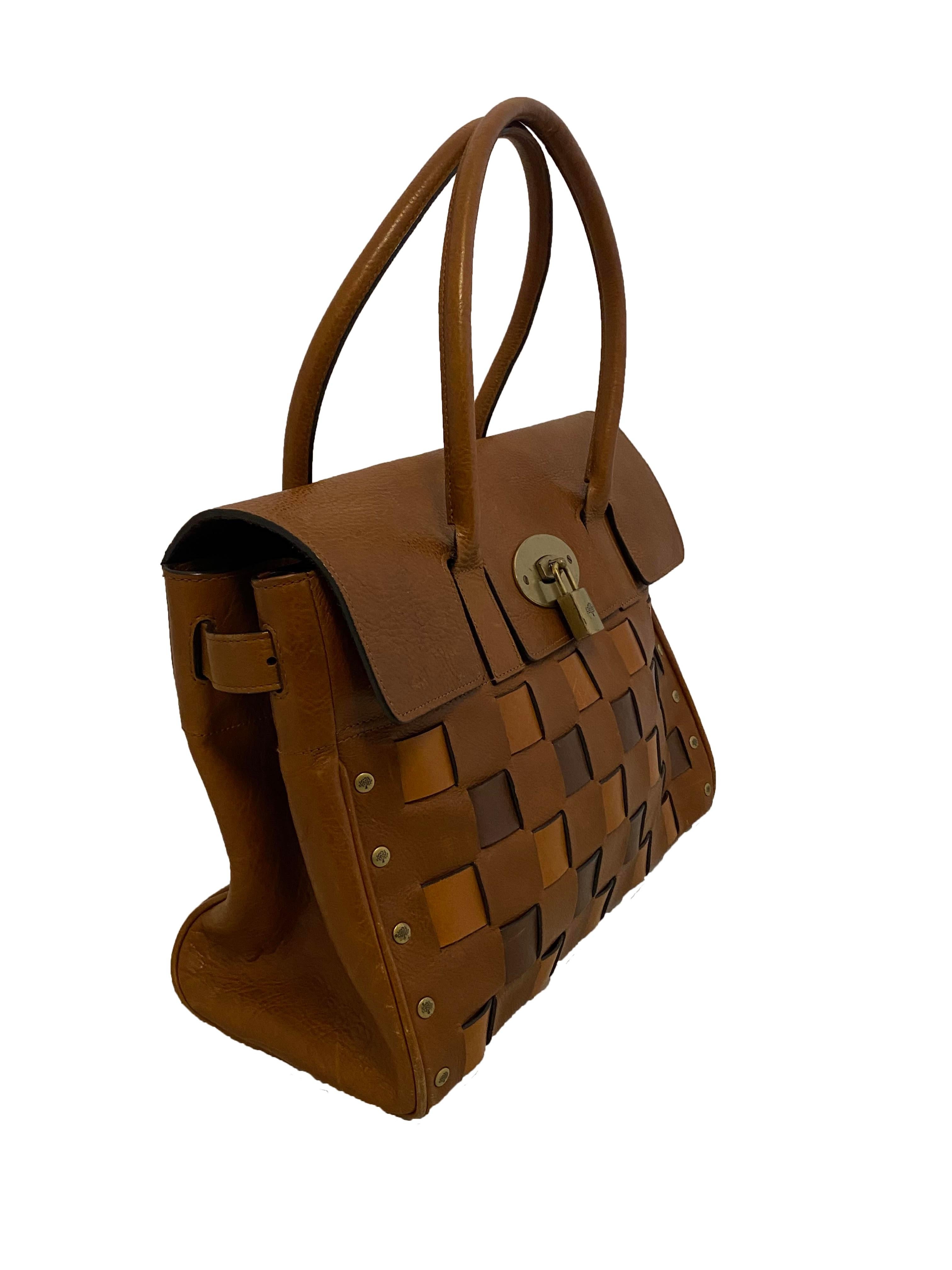 Rare vintage woven leather Bayswater bag from Mulberry. Tan leather upper with woven, intrecciato style leather in shades of lighter and darker brown leather across the front. Brassy toned hardware and tooling, with double rolled leather top
