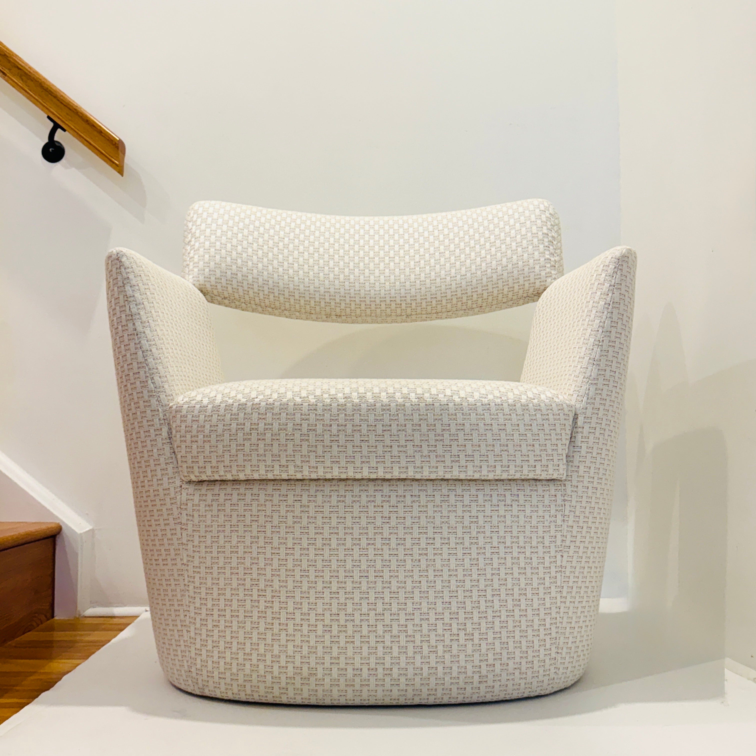 Modernist chair designed by Goncalo Compos for Pierre Frey. The armchair features a suspended backrest with graphic angular lines against a round base. Completely upholstered in Pierre Frey's Sete Chaux, a performance linen fabric that can be used