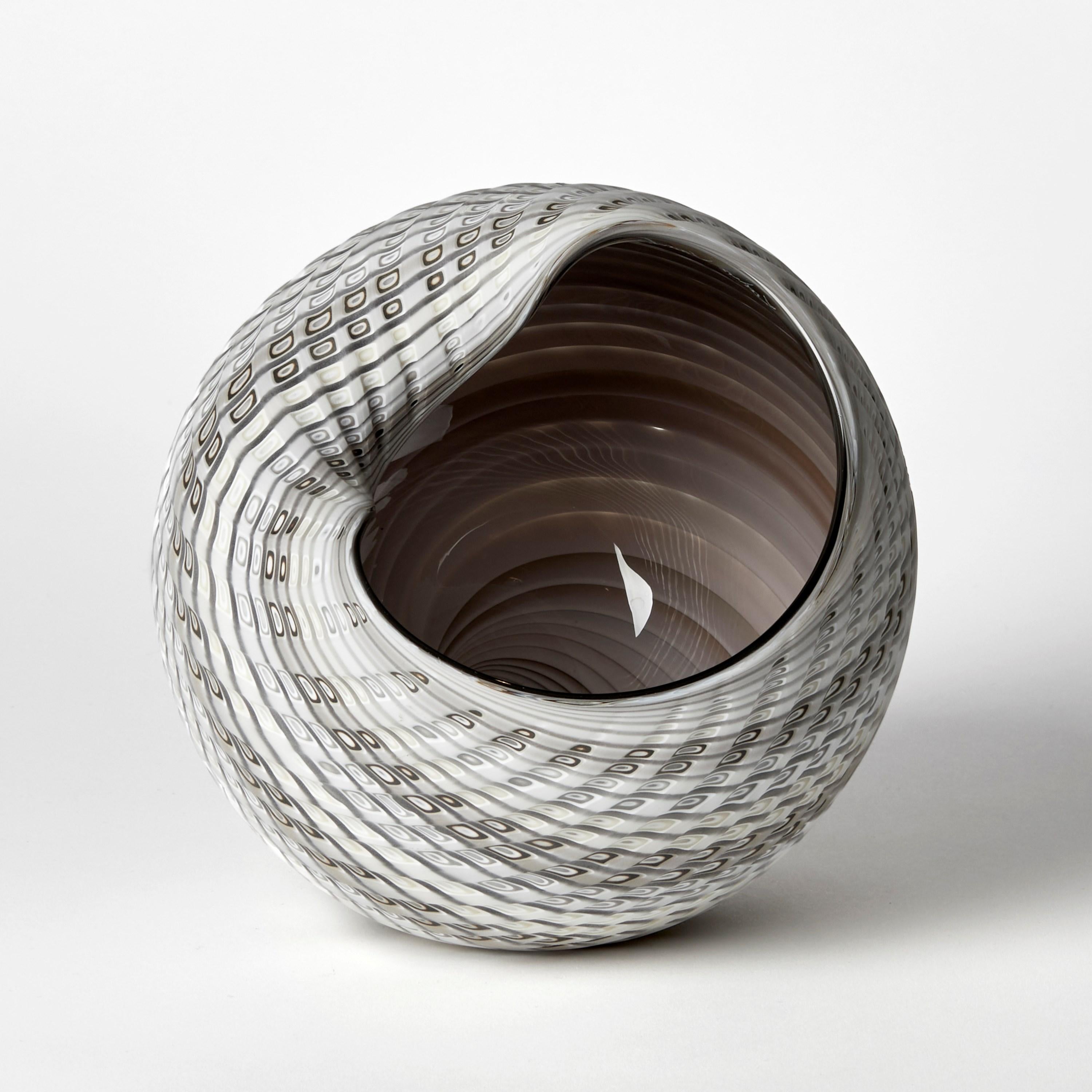 'Woven Mandala (Lg I)' is a unique handblown, sculpted and cut glass sculpture by the British artist, Layne Rowe.

Rowe’s inspiration is drawn from the dramatic Devon coastline which informs his love for detail, a constant theme for his