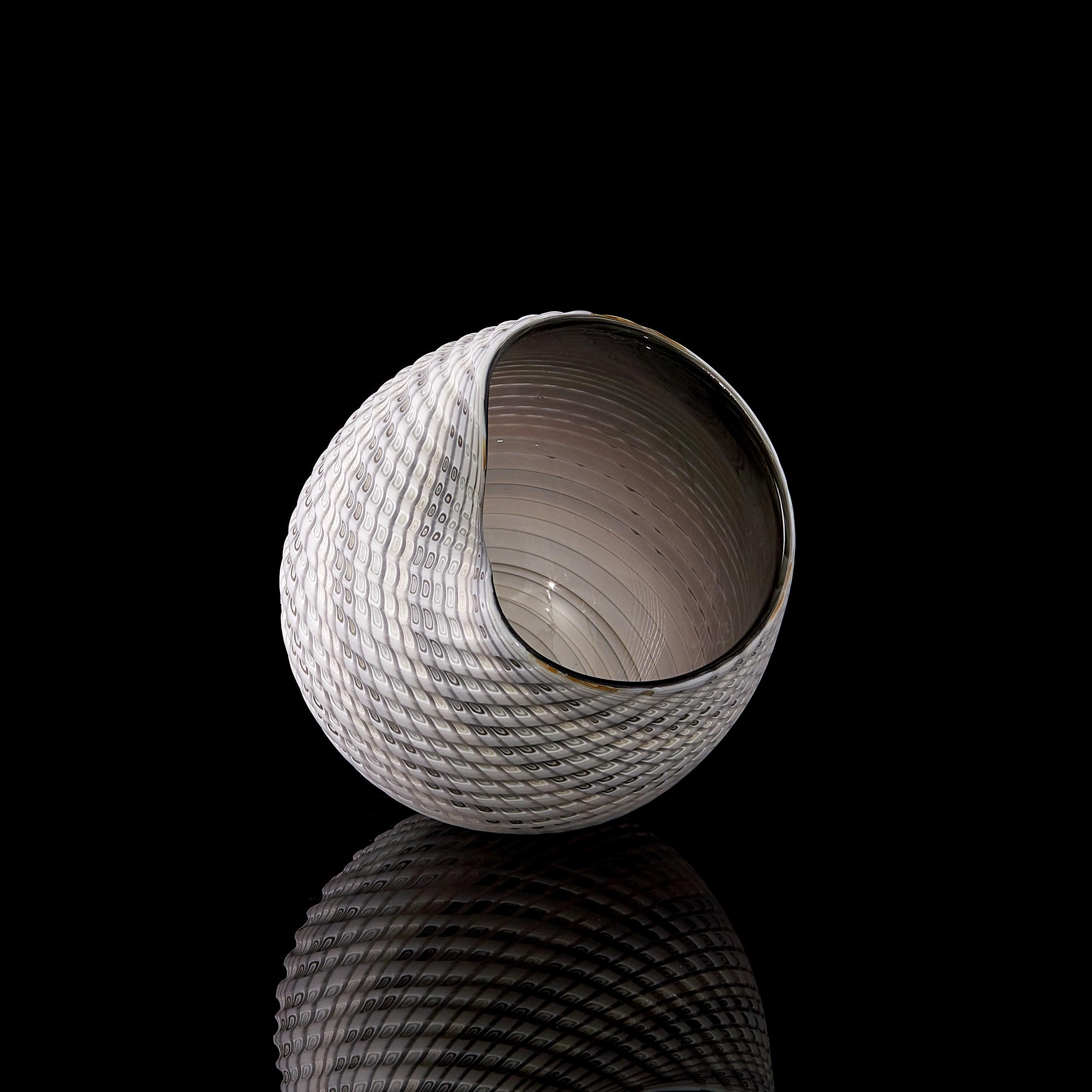 'Woven Mandala No 2' is a unique handblown, sculpted and cut glass sculpture by the British artist, Layne Rowe.

Rowe’s inspiration is drawn from the dramatic Devon coastline which informs his love for detail, a constant theme for his