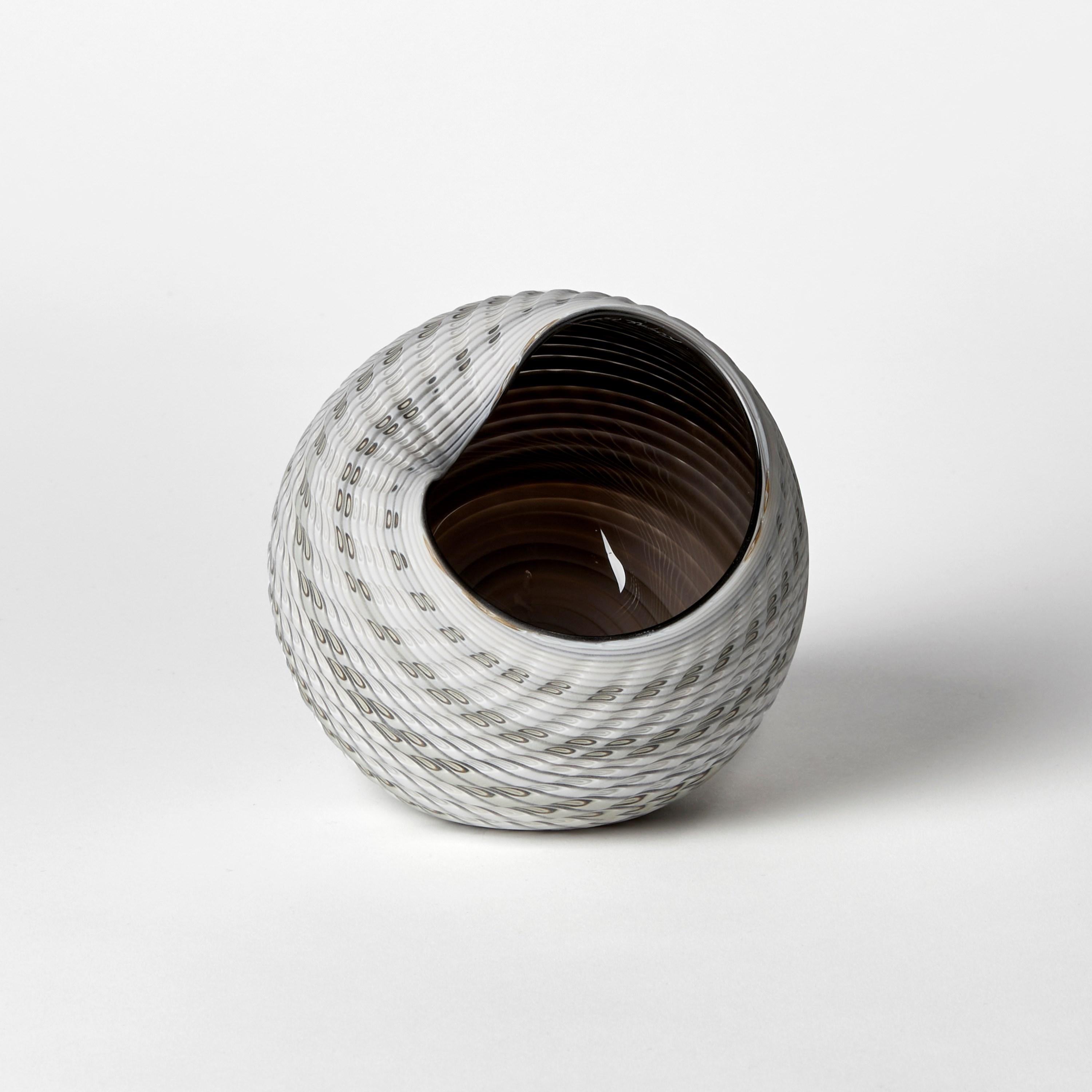 'Woven Mandala (Sm I)' is a unique handblown, sculpted and cut glass sculpture by the British artist, Layne Rowe.

Rowe’s inspiration is drawn from the dramatic Devon coastline which informs his love for detail, a constant theme for his