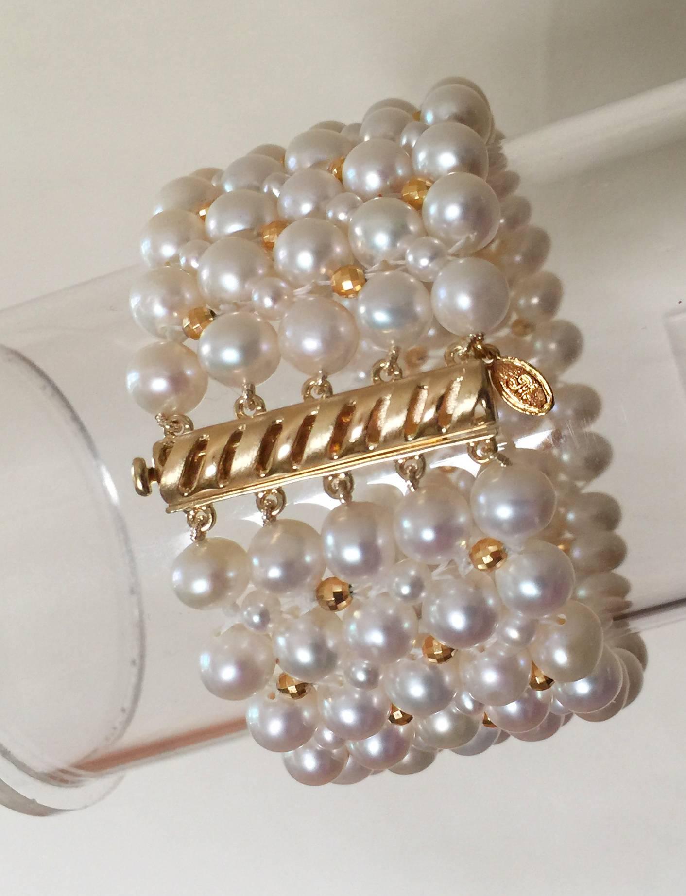 This timeless bracelet has an elegant pearl weave. At 1.25 inches wide the different size pearls create a checkered design with the 14 k  yellow gold plated faceted beads. 
The bracelet is 7.25 inches and fits comfortably on the wrist like a band.