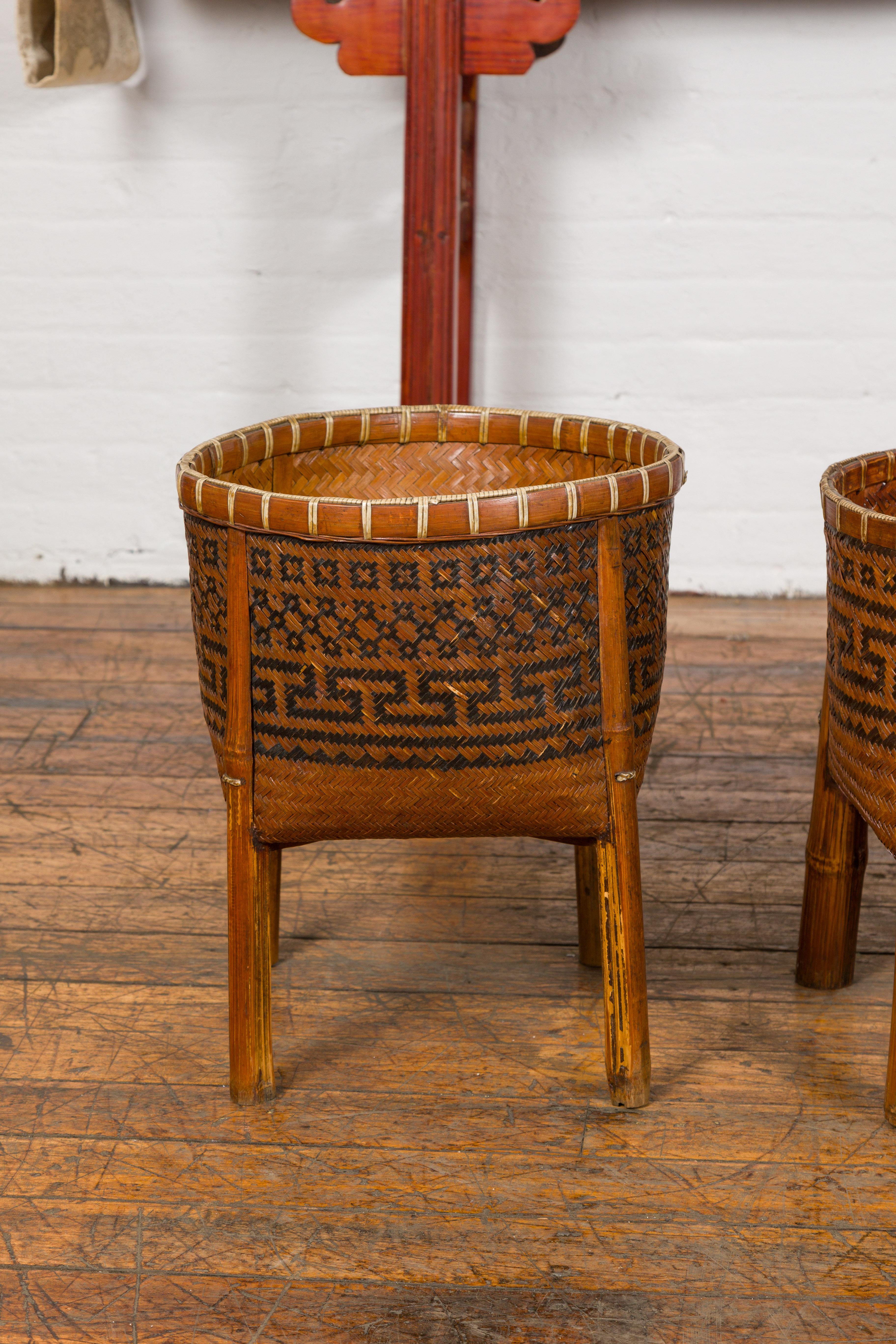 Rustic Woven Rattan Baskets on Legs with Greek Key Motifs, Four Pieces Sold Each For Sale