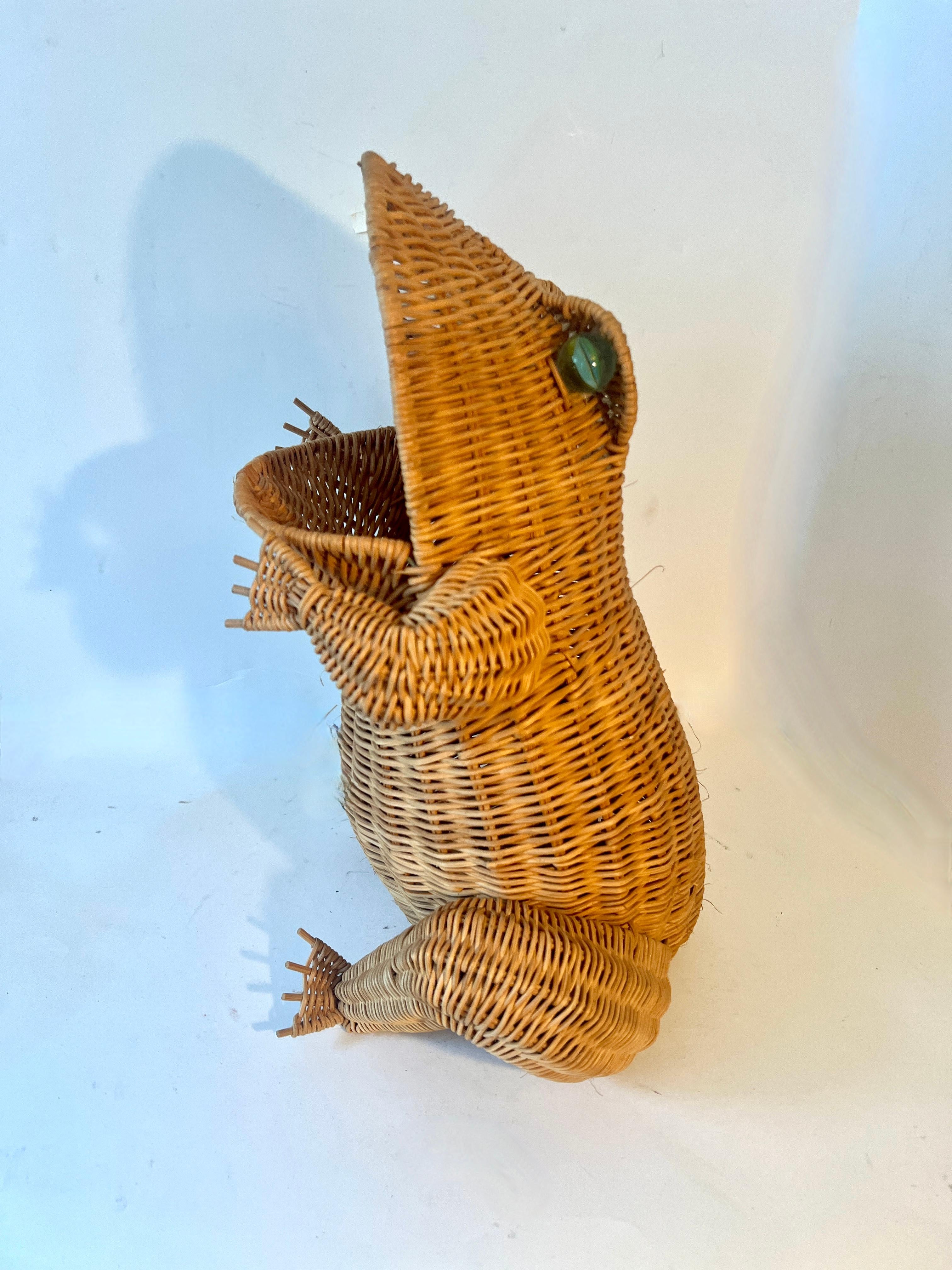 A wonderful rattan basket in the style of Mario Lopez Torres.   The frog figure is well made with no condition issues and has huge marble eyes.

A compliment to any space as a magazine holder, catch all, knitting basket, or simply as a decorative