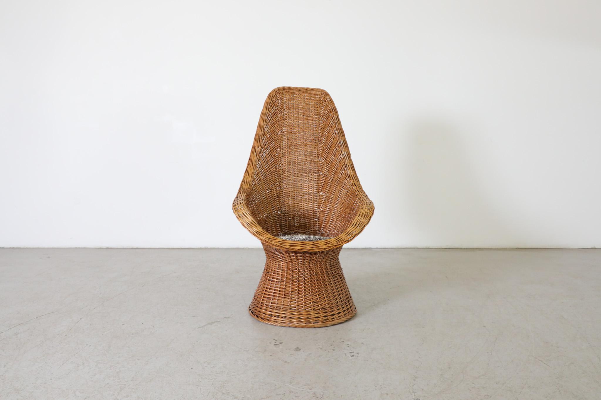 Mid-Century hand-woven 'Peacock' style boho rattan lounge chair attributed to famed Dutch designer Dirk van Sliedregt. High back rattan lounger perfect for adding an earthy touch of style to any indoor living space or for bolstering the organic