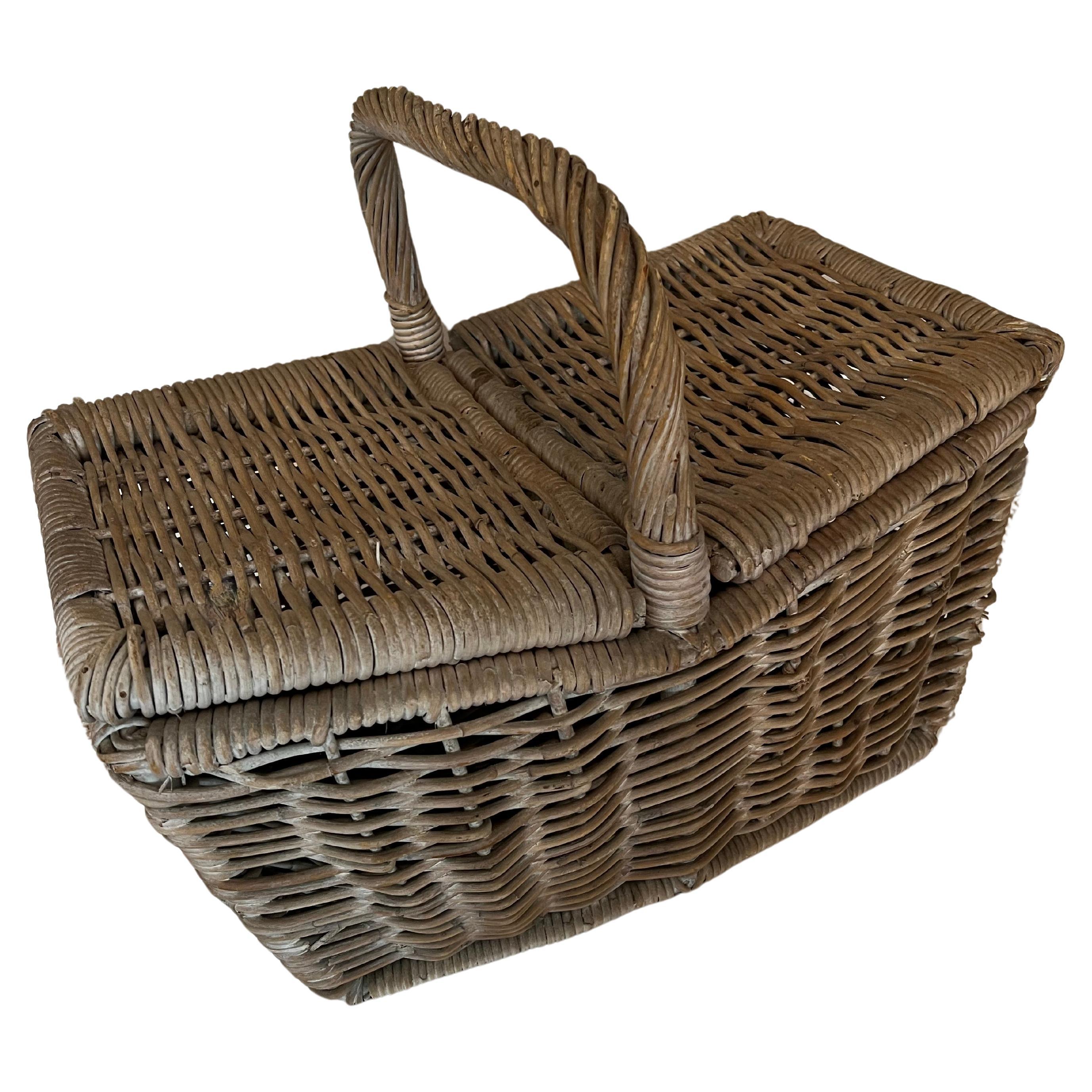 A wonderful Picnic Basket - Woven of heavy rattan  - a center opening with duo sides for easy access.  A spacious basket for a hearty meal, bottle of wine and picnic accessories.

A lovely practical piece, which also doubles as a handsome decorative