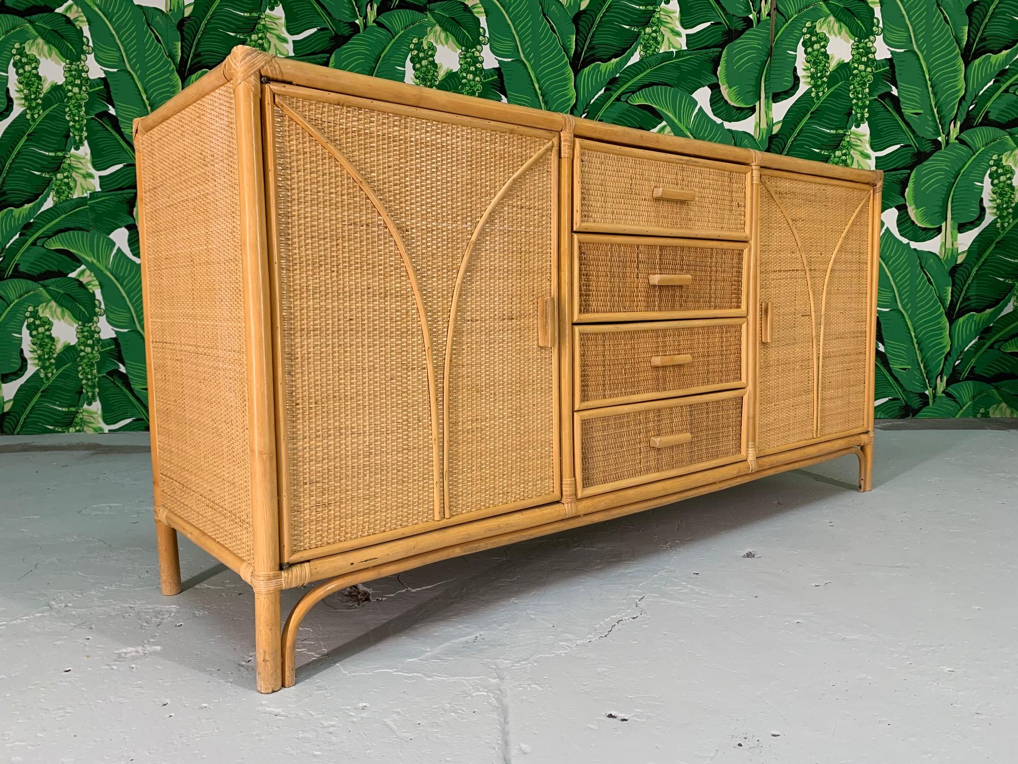 Vintage tiki-style dresser features rattan construction and woven rattan veneers. Solid construction and minimal imperfections consistent with age.