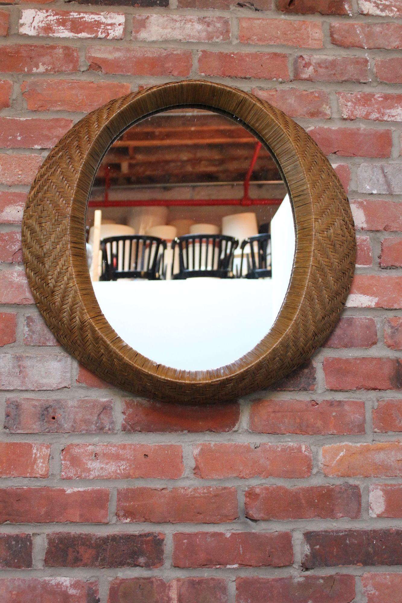 Striking, Italian-style wall mirror in stained woven rattan designed by Matt Carr for Umbra (ca. 2001, Canada).
Excellent condition with only light patina/wear to the rattan.
H: 24