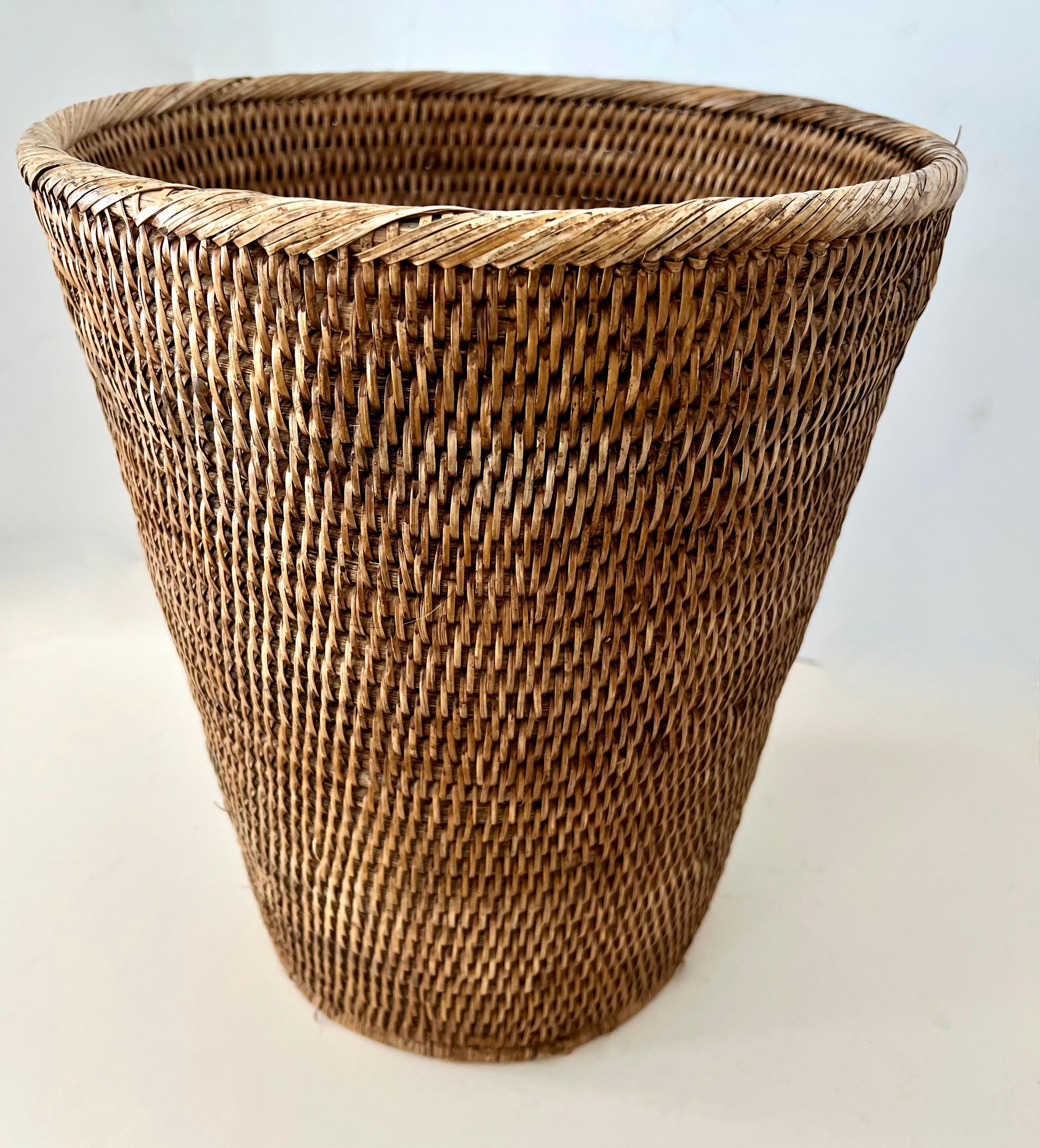 A handsome and heavily woven rattan or straw waste can - the piece is substantial and very sturdy. A compliment to any office or space that lends itself to a neutral, clean, traditional or organic look. Also would work wonderfully in a modern