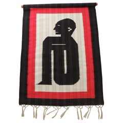 Woven Red and Black Wall-Hanging Depicting Seating Man